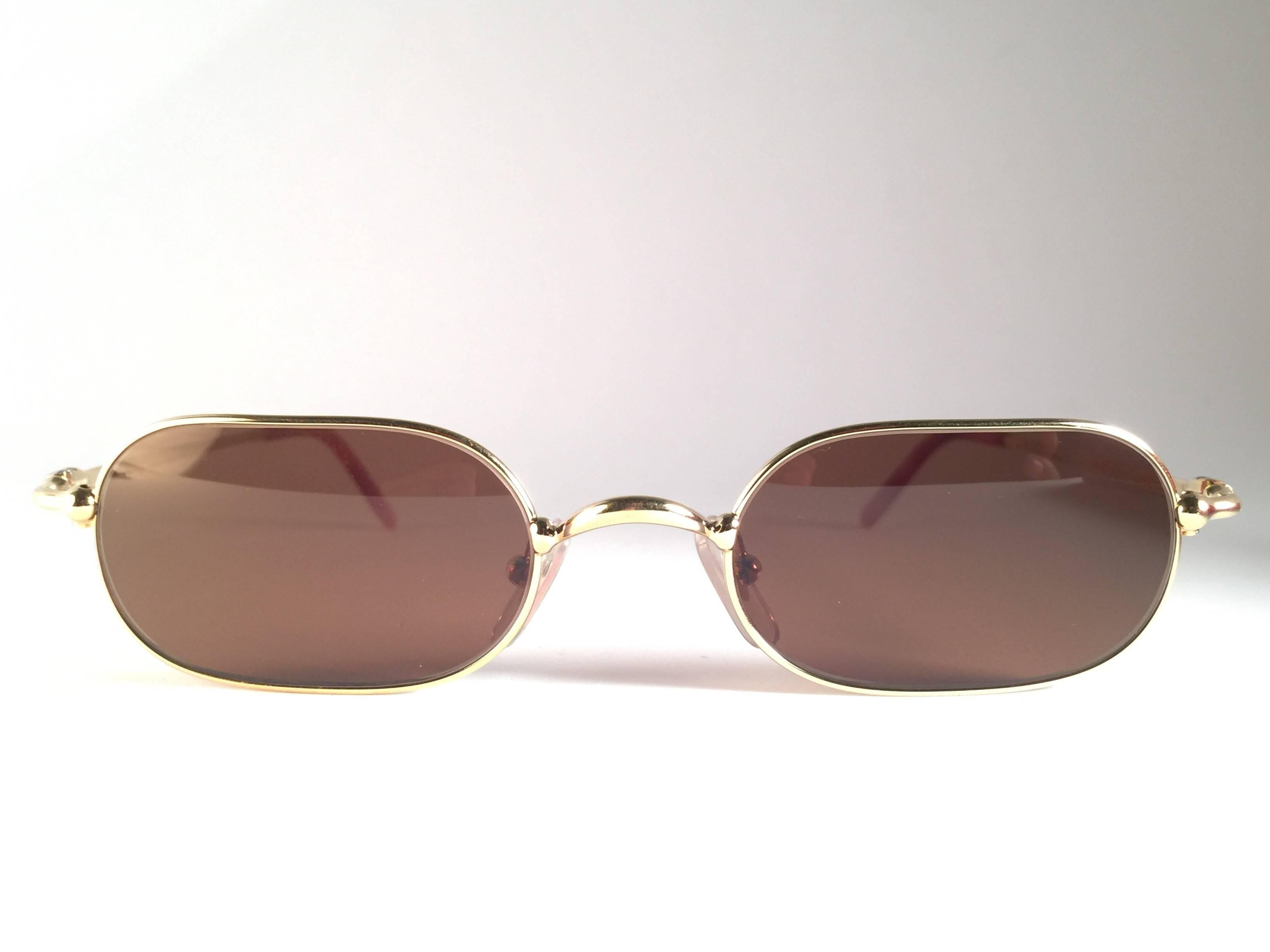 
New 1990 Cartier Orfy 50 [] 21 Sunglasses with brown (uv protection) lenses.
All hallmarks. Cartier gold signs on the ear paddles. These are like a pair of jewels on your nose. Beautiful design and a real sign of the times. Please notice this item