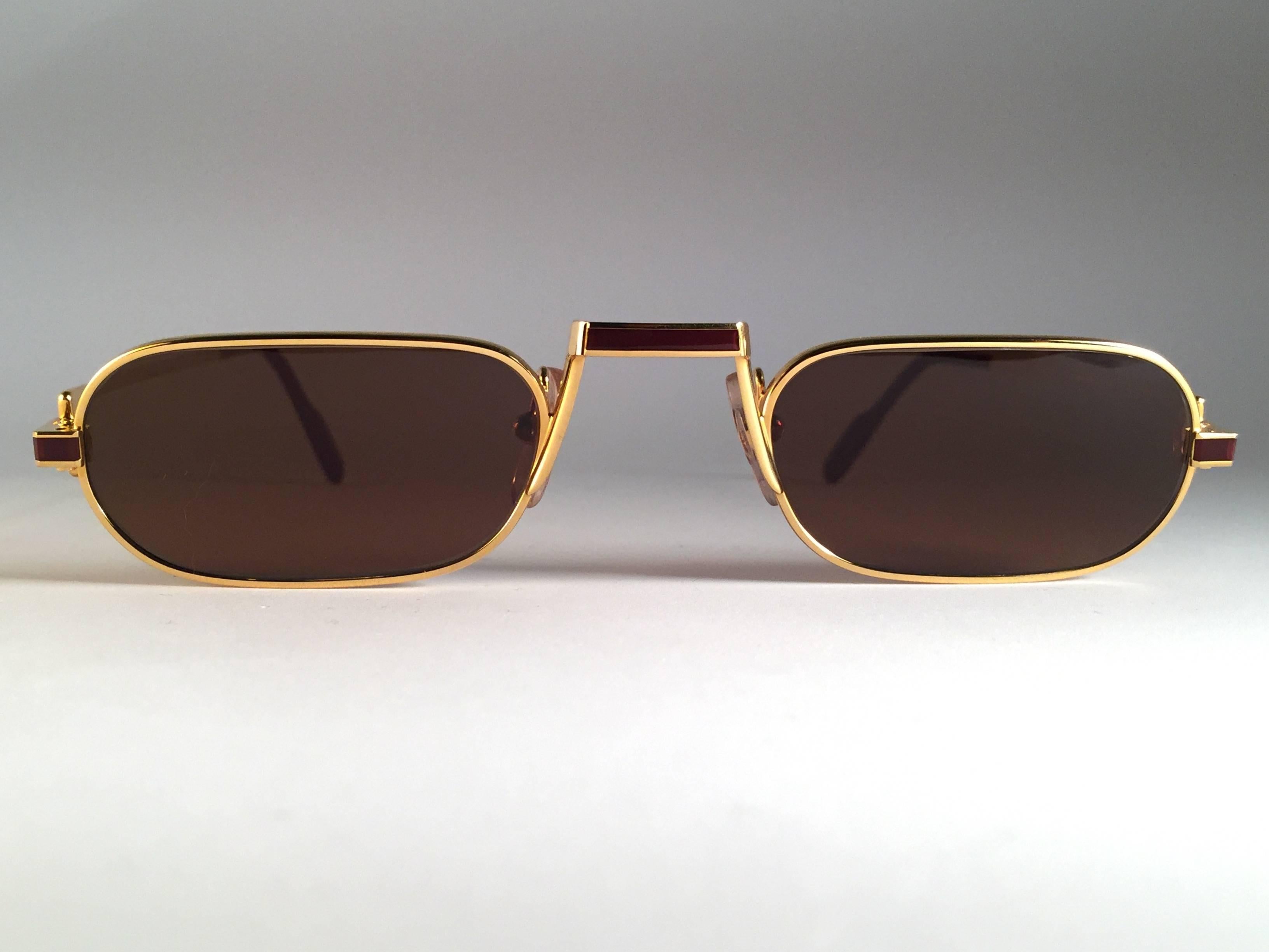 Original 1983 Cartier Demilune Cartier Laque De Chine sunglasses with new honey brown lenses. Very comfortable as reading glasses. All hallmarks. Red enamel with Cartier gold signs on the burgundy ear paddles. Both arms sport the C from Cartier on