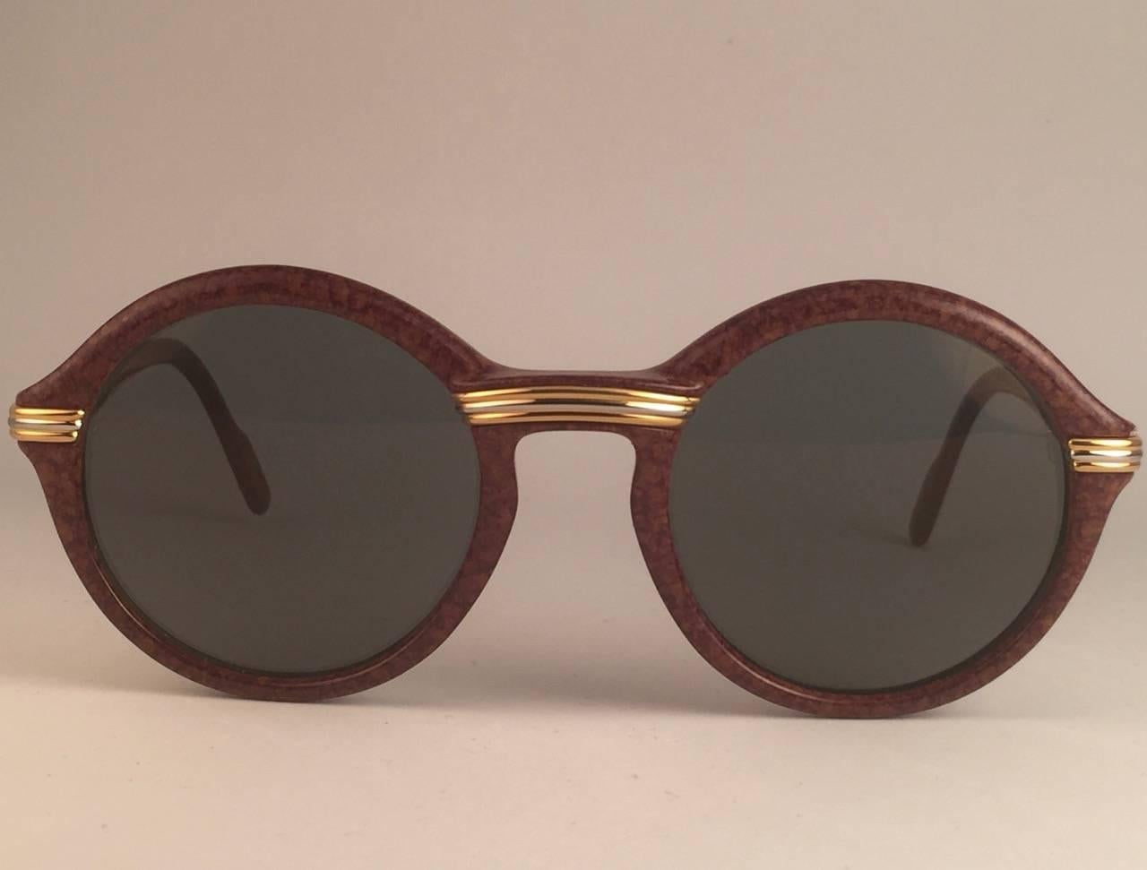 New 1991 Original Cartier Cabriolet Art Deco sunglasses with slight gold mirror ( uv protection ) lenses. 
Frame has the famous real gold and white gold accents in the middle and on the sides.  All hallmarks. Cartier gold signs on the earpaddles.
