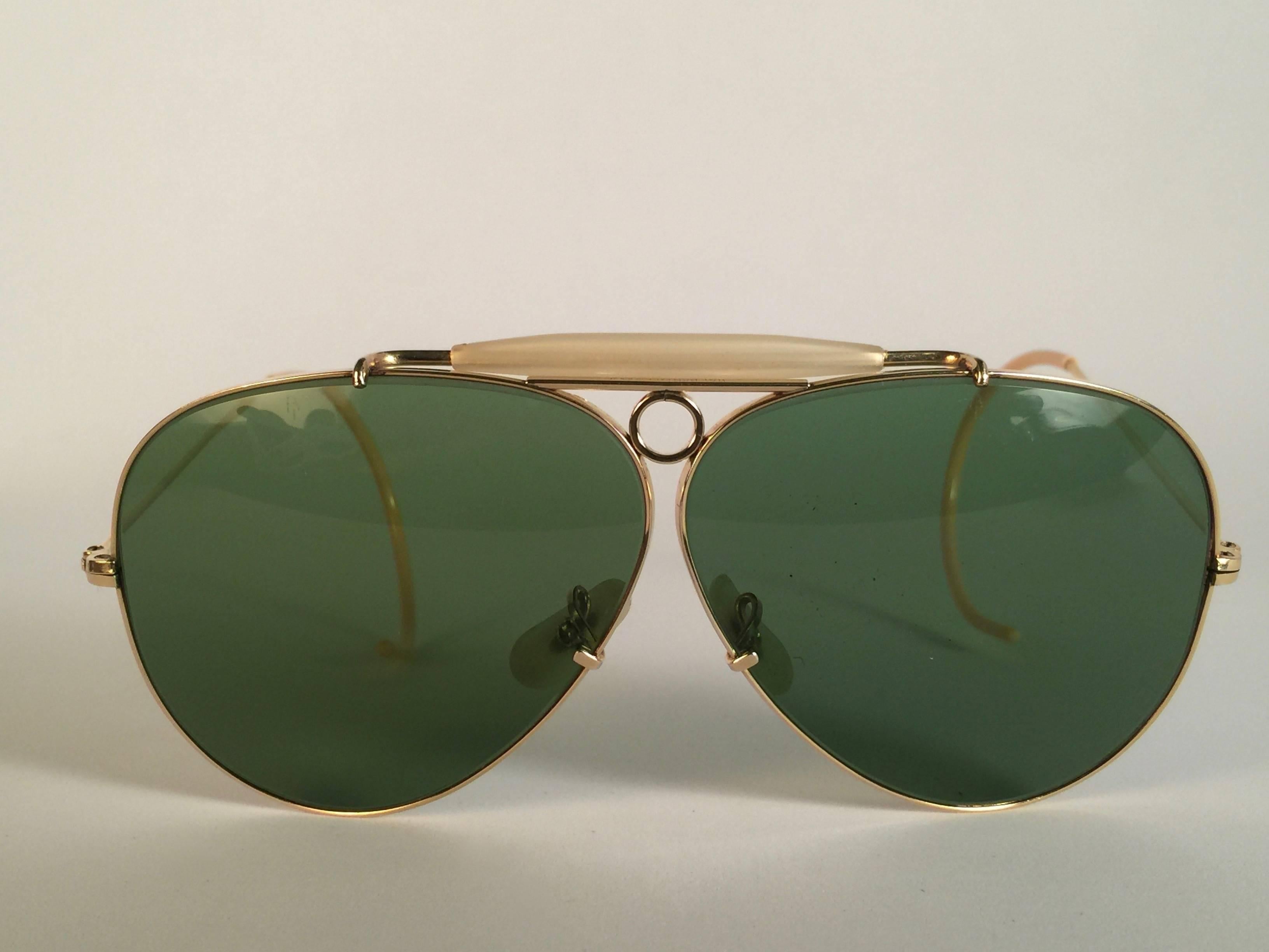 Superb pair Of Ray Ban Classic Outdoorsman 62Mm with 12K gold filled frame.  Gold filigree temples1950's USA Made by Bausch and Lomb. Original True Green RB3 B&L lenses. Frame straight as an arrow with mother of pearl browser. All the hallmarks.