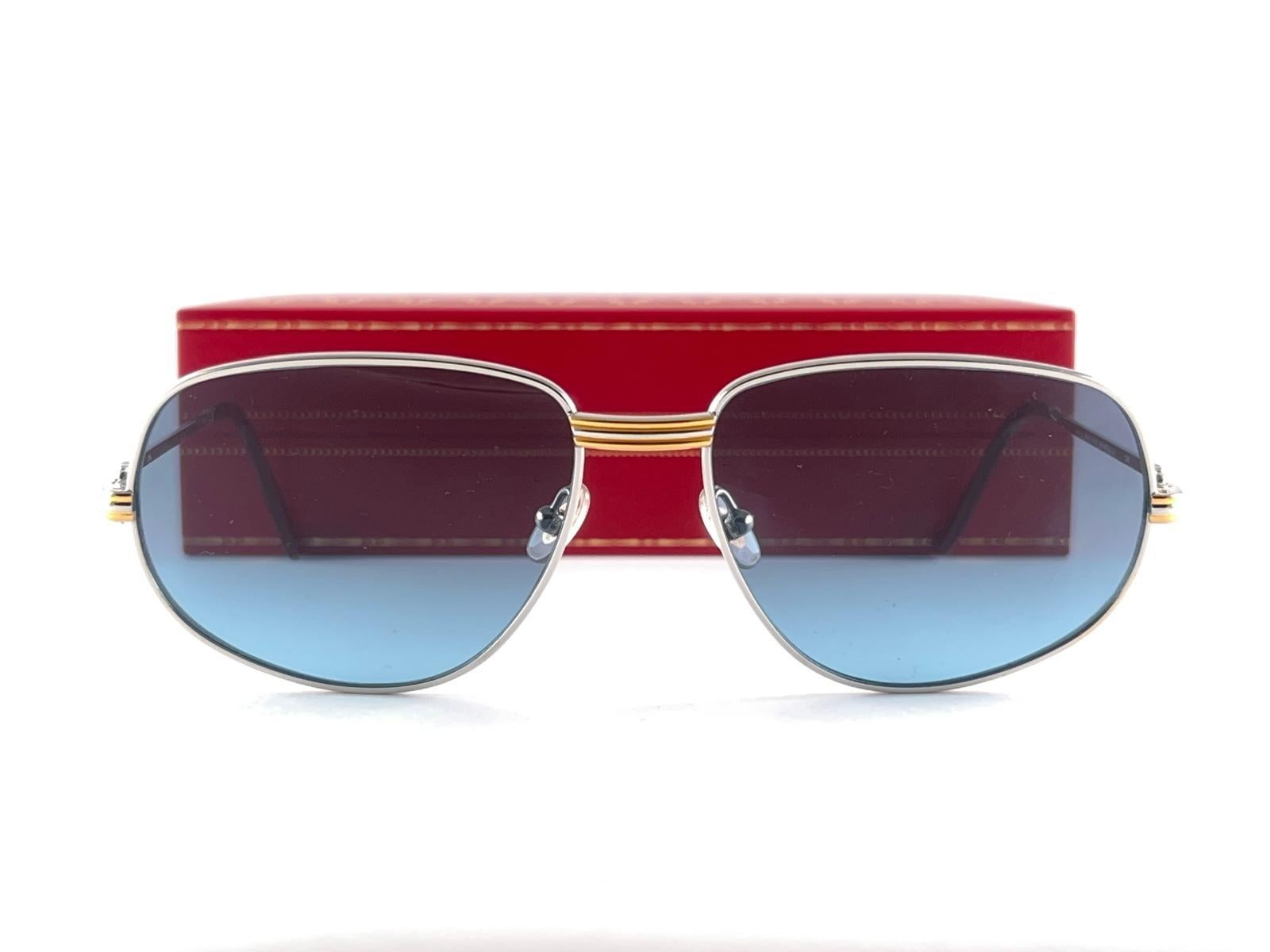 Vintage Cartier Romance Vendome Platinum sunglasses with blue gradient (uv protection) lenses.  Frame is with the front and sides in yellow and white gold. All hallmarks. Red enamel with Cartier gold signs on the ear paddles. Both arms sport the C