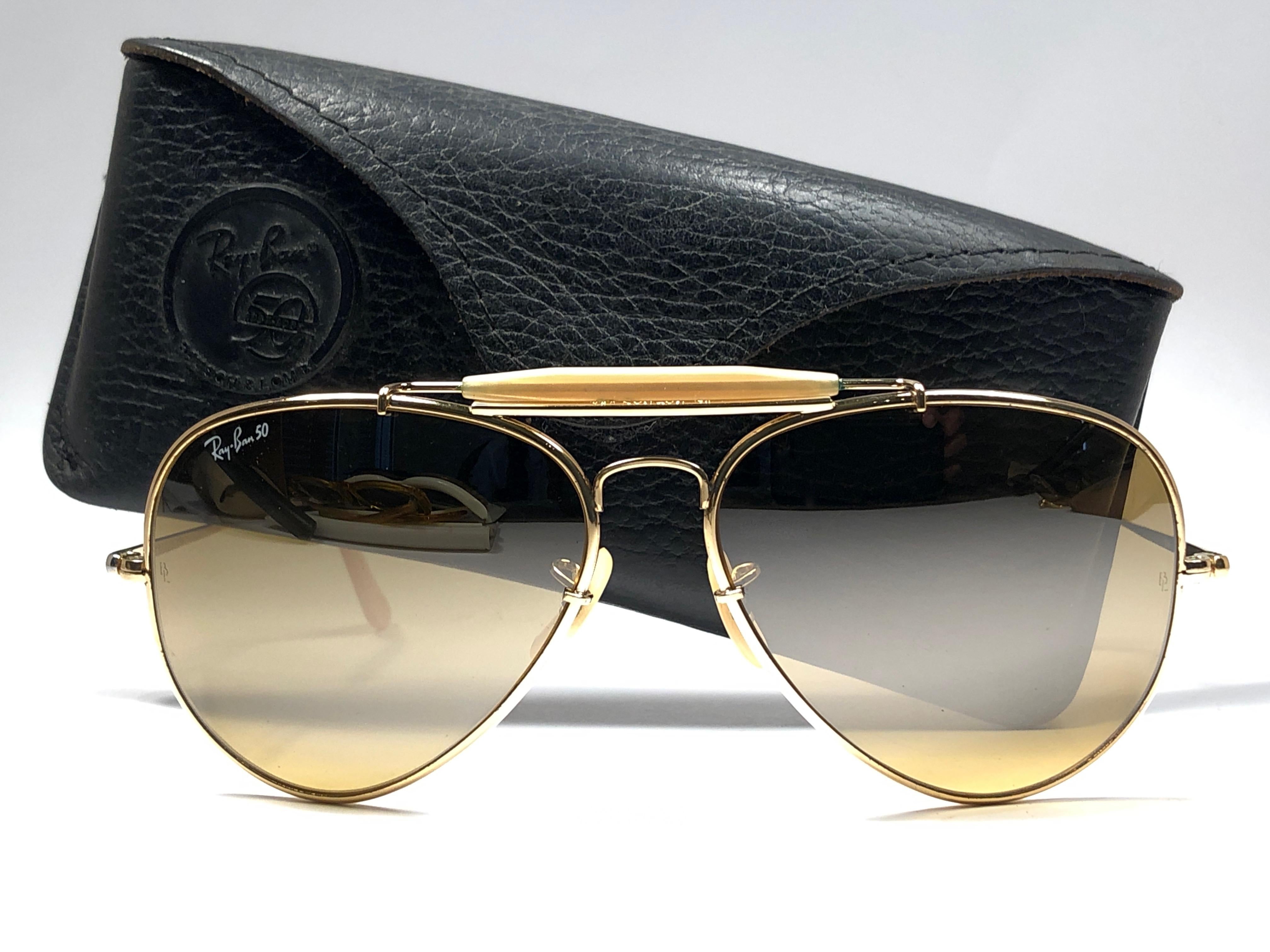 Mint 50th Anniversary Edition 1937-1987 Ray Ban The General Gold Bravura frame with the extra strong temples. 
RB 50 Ambermatic mirror lenses. Ray Ban 50 written on the right lens. B&L Ray Ban Usa. Under the bridge 62 [] 14. Comes with original