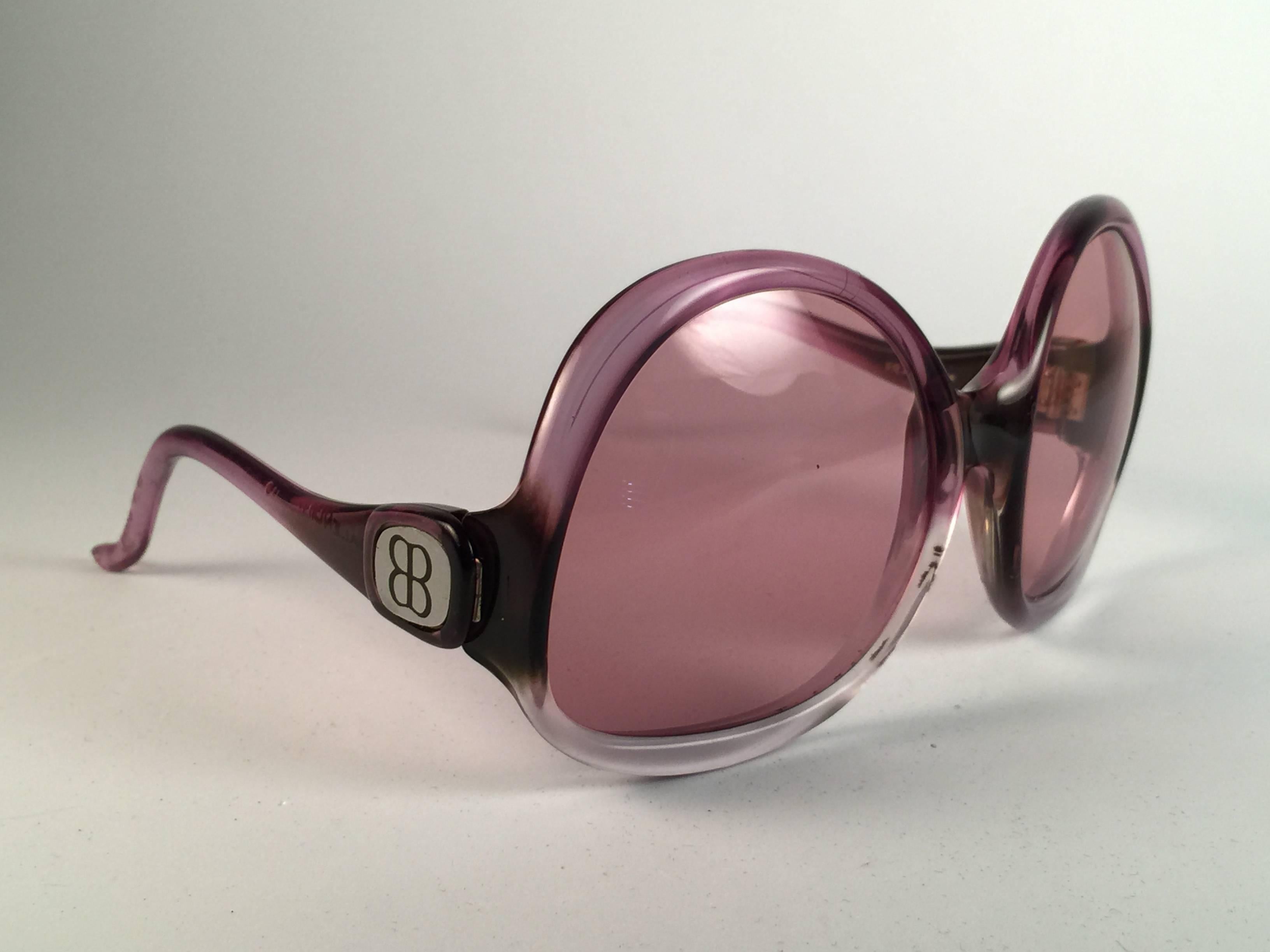 New Vintage Balenciaga clear and magenta oversized frame holding a spotless pair of light rose lenses.  Never worn or displayed. This pair could show minor sign of wear due to storage.  Designed and produced in France.