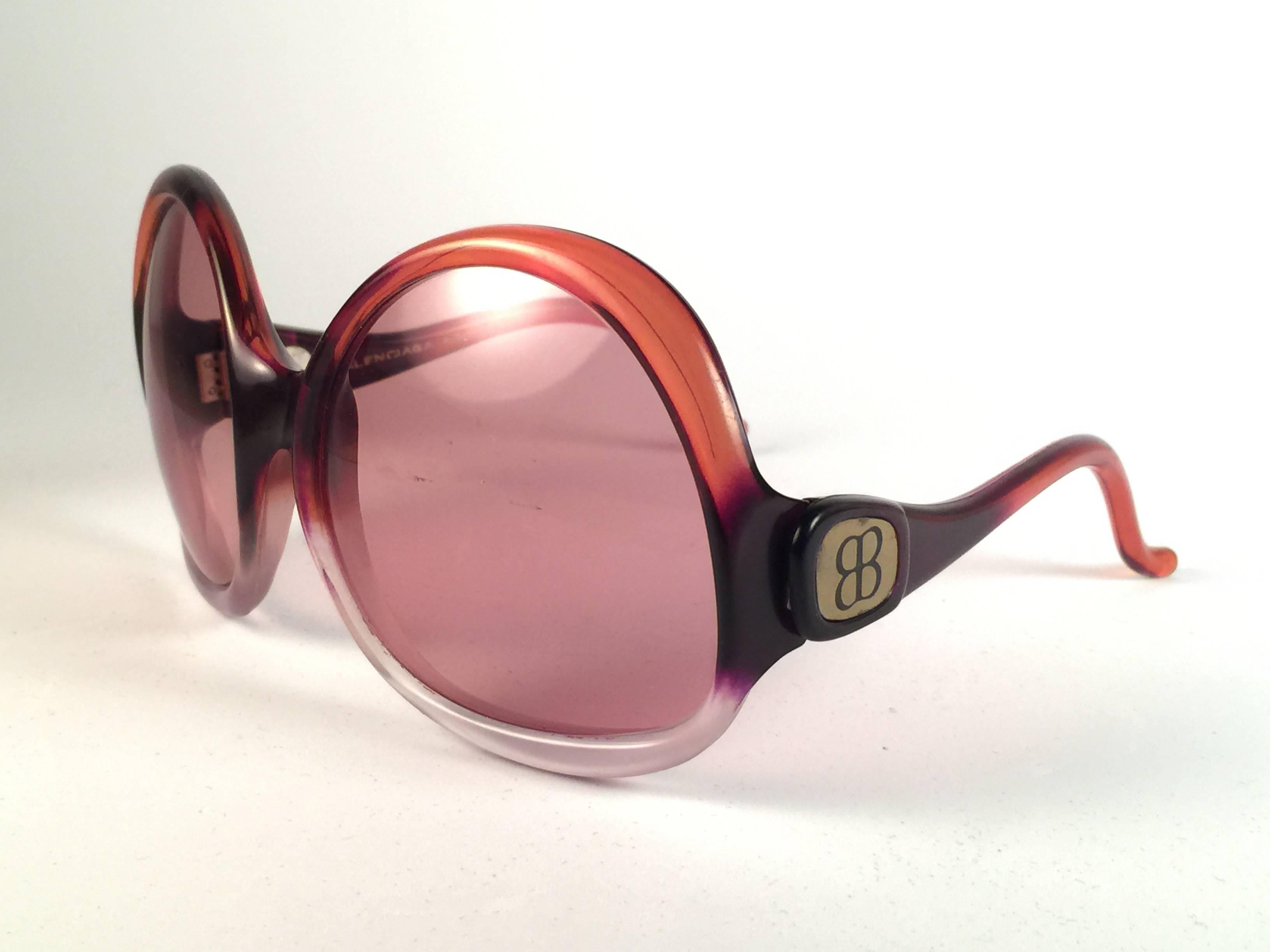New Vintage Balenciaga clear and orange ombre oversized frame holding a spotless pair of light rose lenses.  Never worn or displayed. This pair could show minor sign of wear due to storage.  Designed and produced in France.