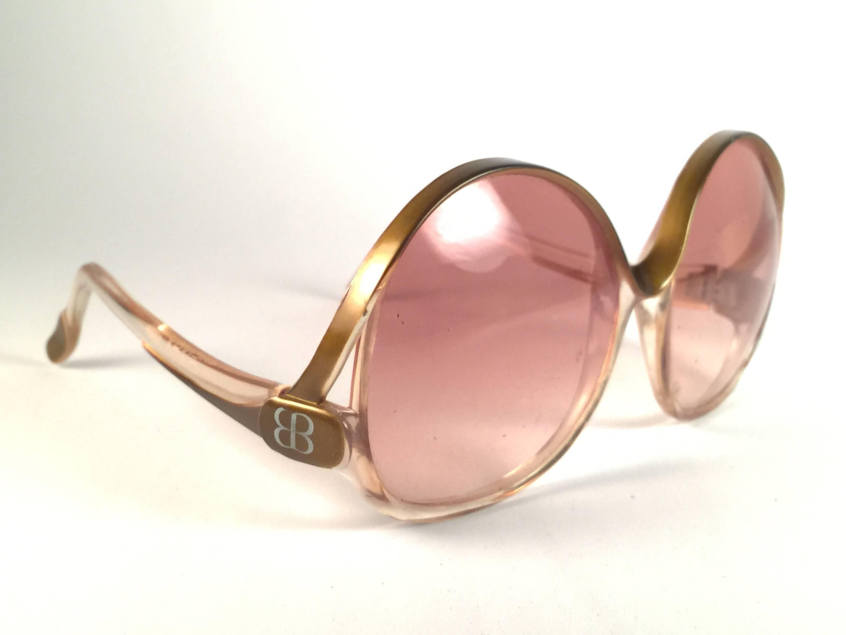 Mint Vintage Balenciaga clear and gold oversized frame holding a spotless pair of light rose lenses.  In very good vintage condition. This pair show minor sign of wear due to storage.  Designed and produced in France.