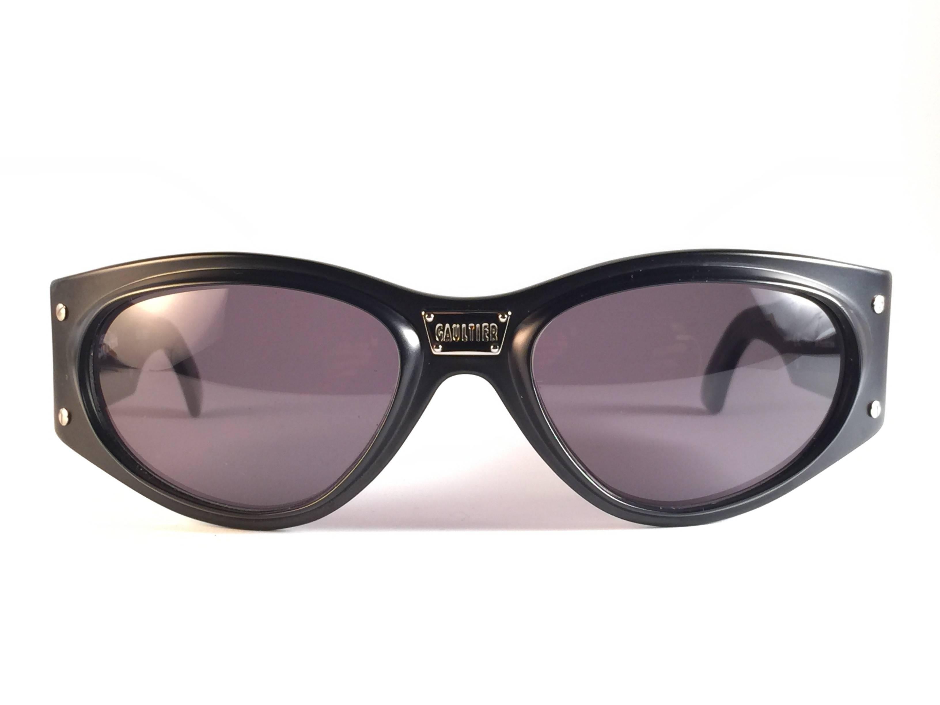 New Jean Paul Gaultier 56  5001 black frame with silver inserts frame.  

Spotless dark grey lenses that complete a ready to wear JPG look.  

Amazing design with strong yet intricate details. 
Design and produced in the 1900's. New, never worn or