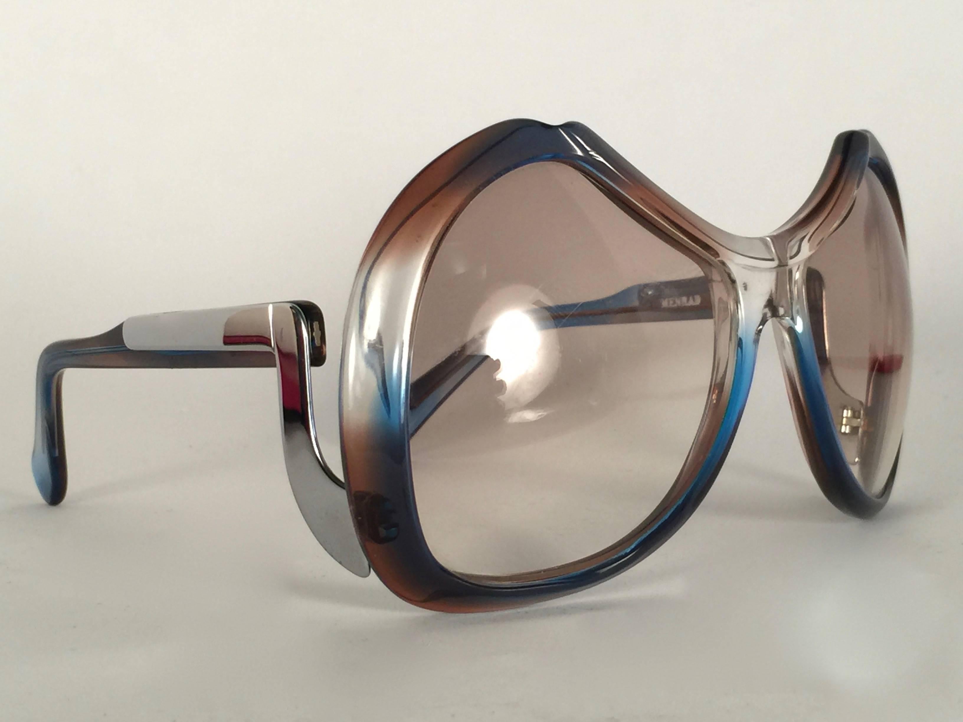 New Vintage Collector Item Menrad Clear Multicolour and Silver Sunglasses frame holding a spotless pair of light gradient lenses.  

Made in Germany in 1970's.