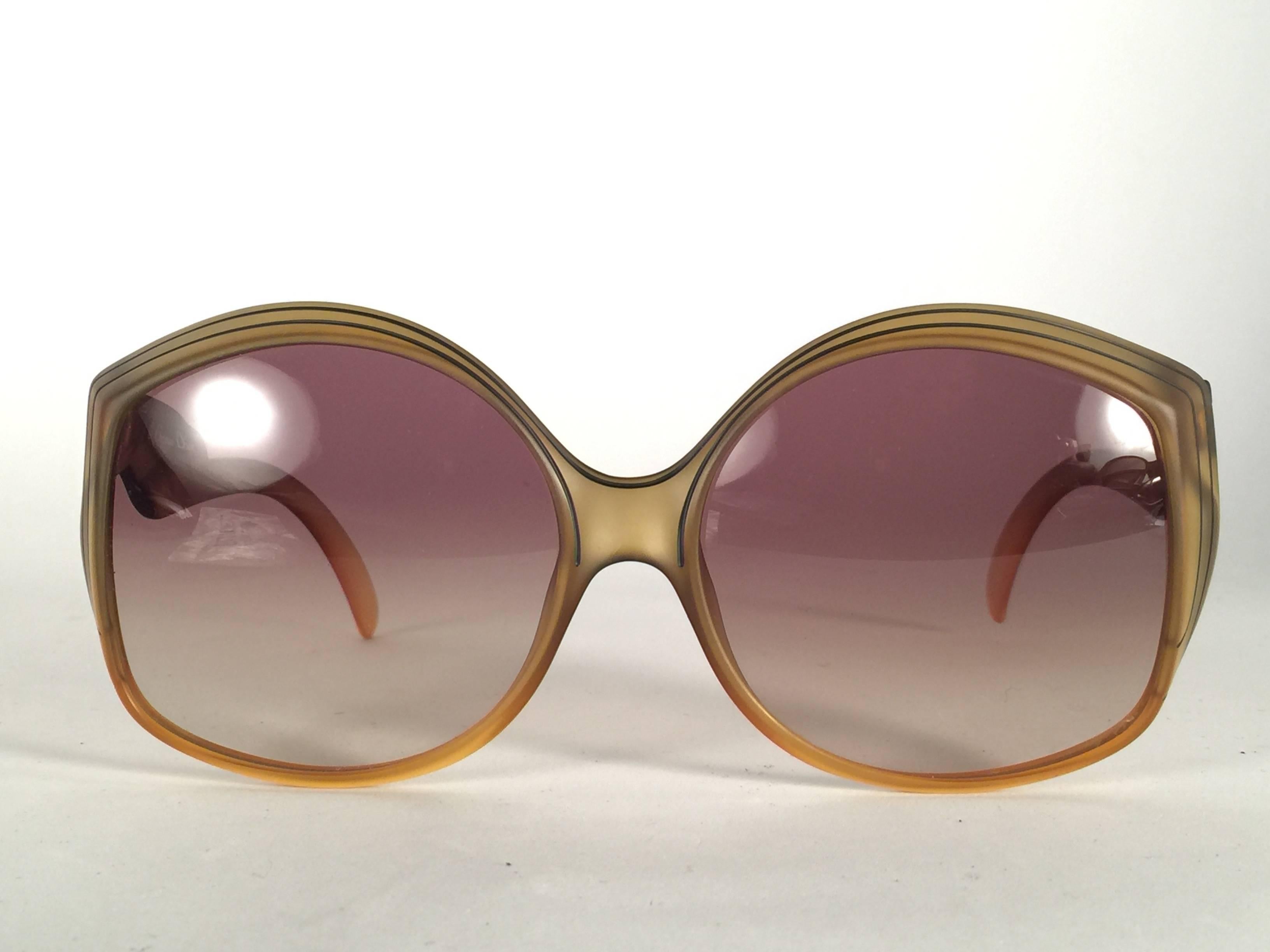New Vintage Christian Dior 2041 10 Green matte with accents frame with spotless light  gradient lenses. 

Made in Austria.
 
Produced and design in 1970's.

New, never worn or displayed. Comes with its original silver Christian Dior Lunettes sleeve.
