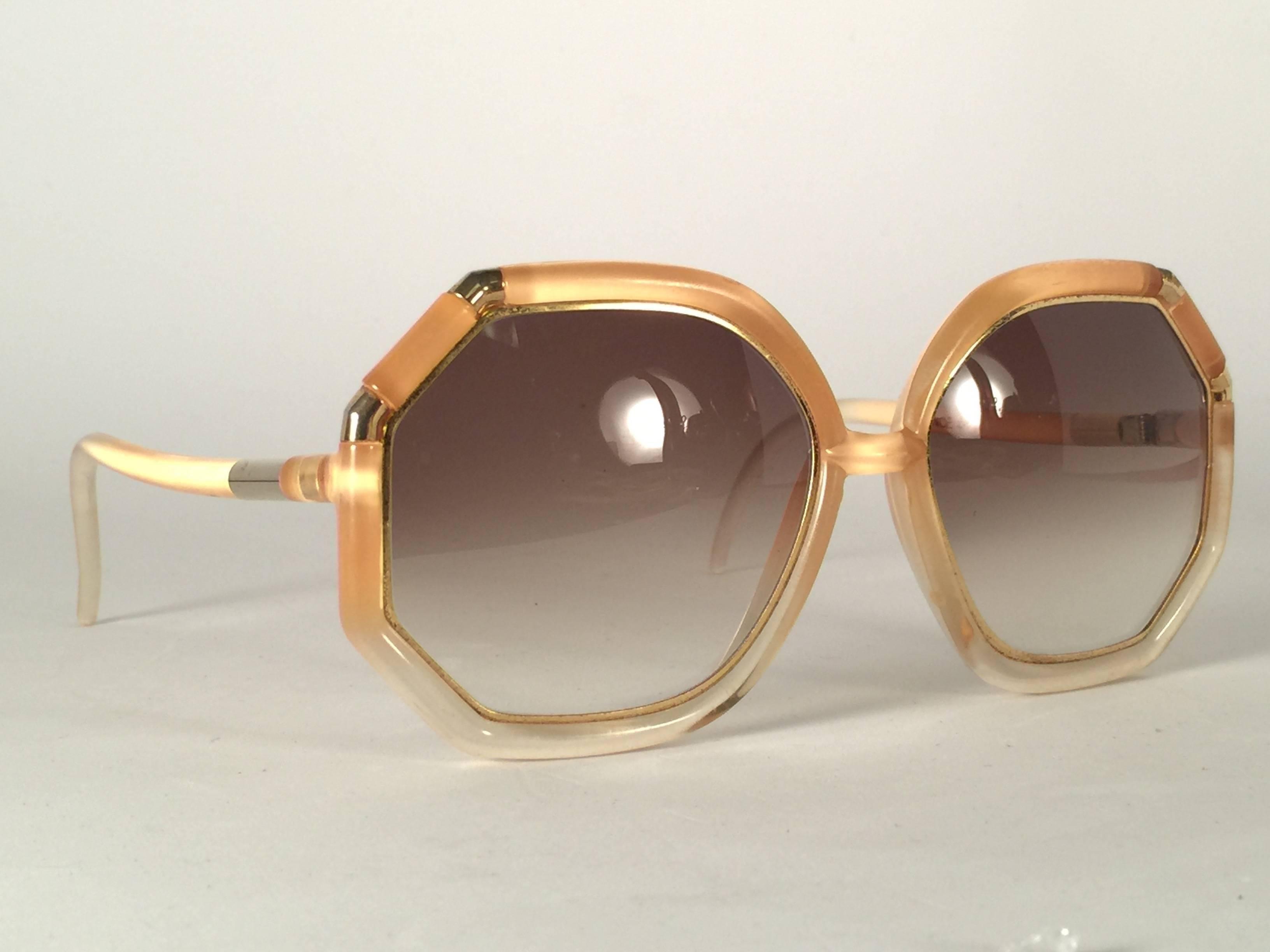 New Vintage Ted Lapidus Amber and gold details with spotless lenses. 

Please consider that this item its nearly 50 years old and could show minor sign of wear or discolouration due to storage. 

Made in Paris. Produced and design in 1970's. New,