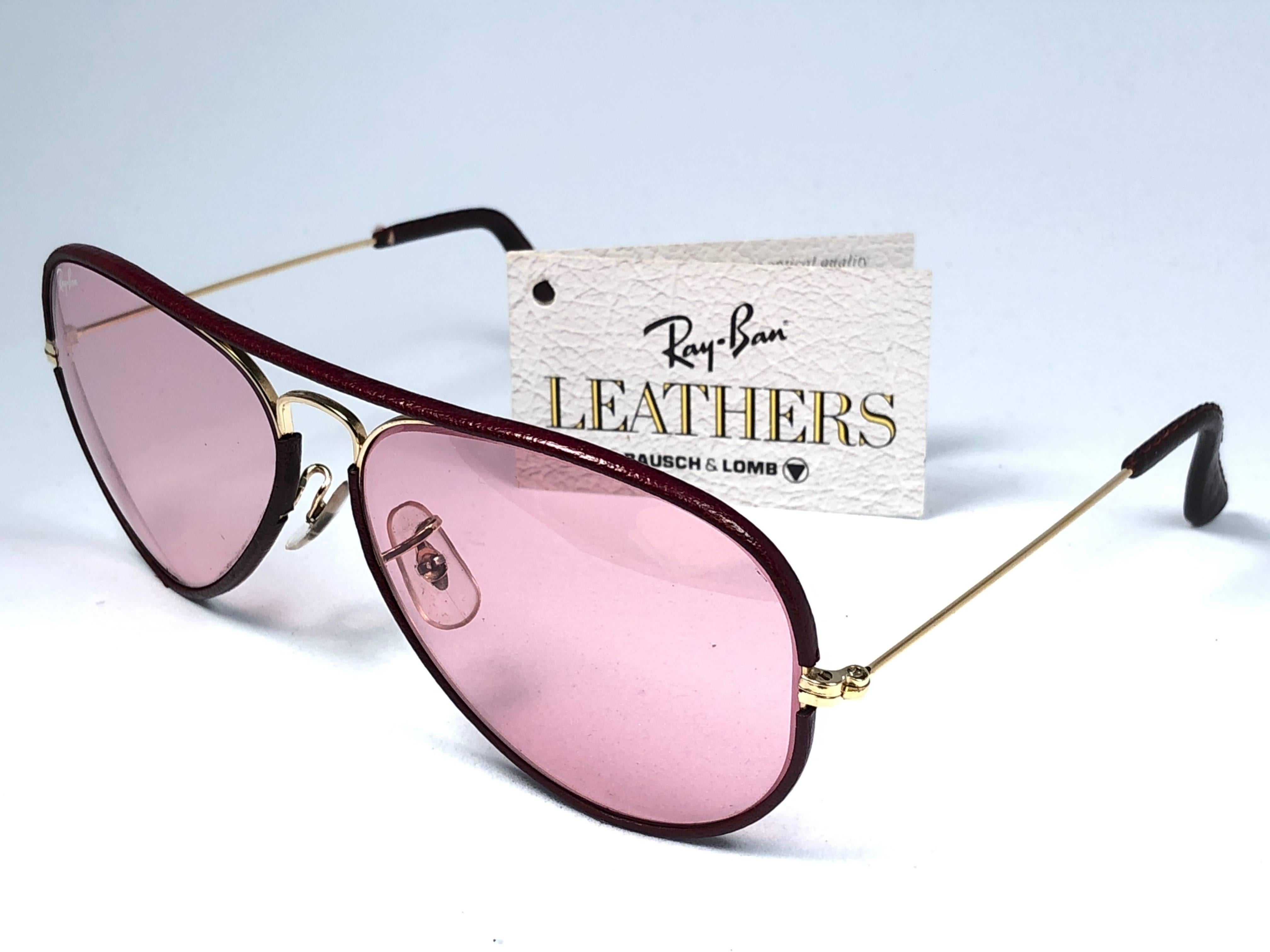 New Vintage Ray Ban Leathers Aviator 58mm in burgundy leather with gold metal combination frame sporting rose changeable lenses.

Comes with its original Ray Ban B&L case. This pair may show minor sign of wear due to storage. 
Rare and hard to find.