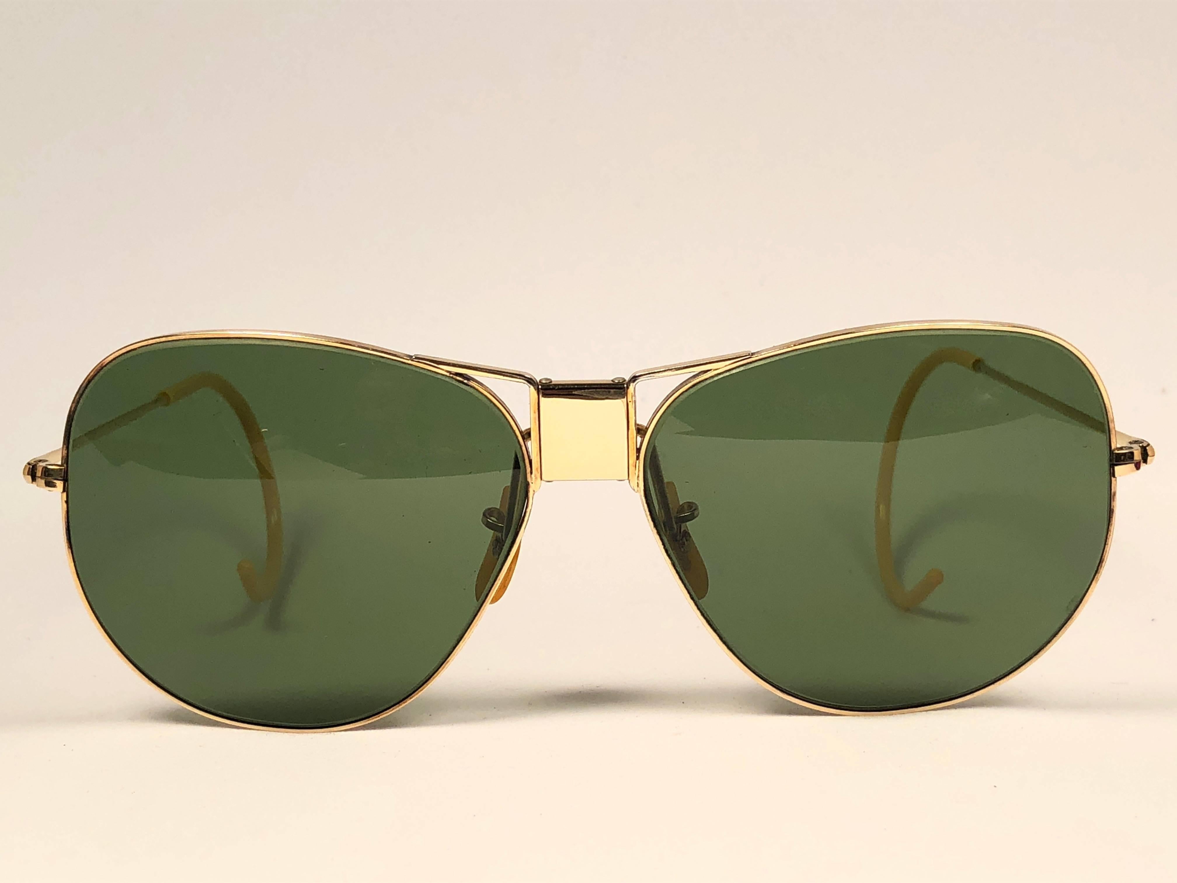 Superb pair. Classic Hinged Butterfly 12K gold filled frame. USA Made by Bausch and Lomb. Original True Green RB3 B&L lenses. 
Marked on top of the bridge BL 12K GF ( Gold Filled ). Amazing original Bausch and Lomb case. The case has stains on the