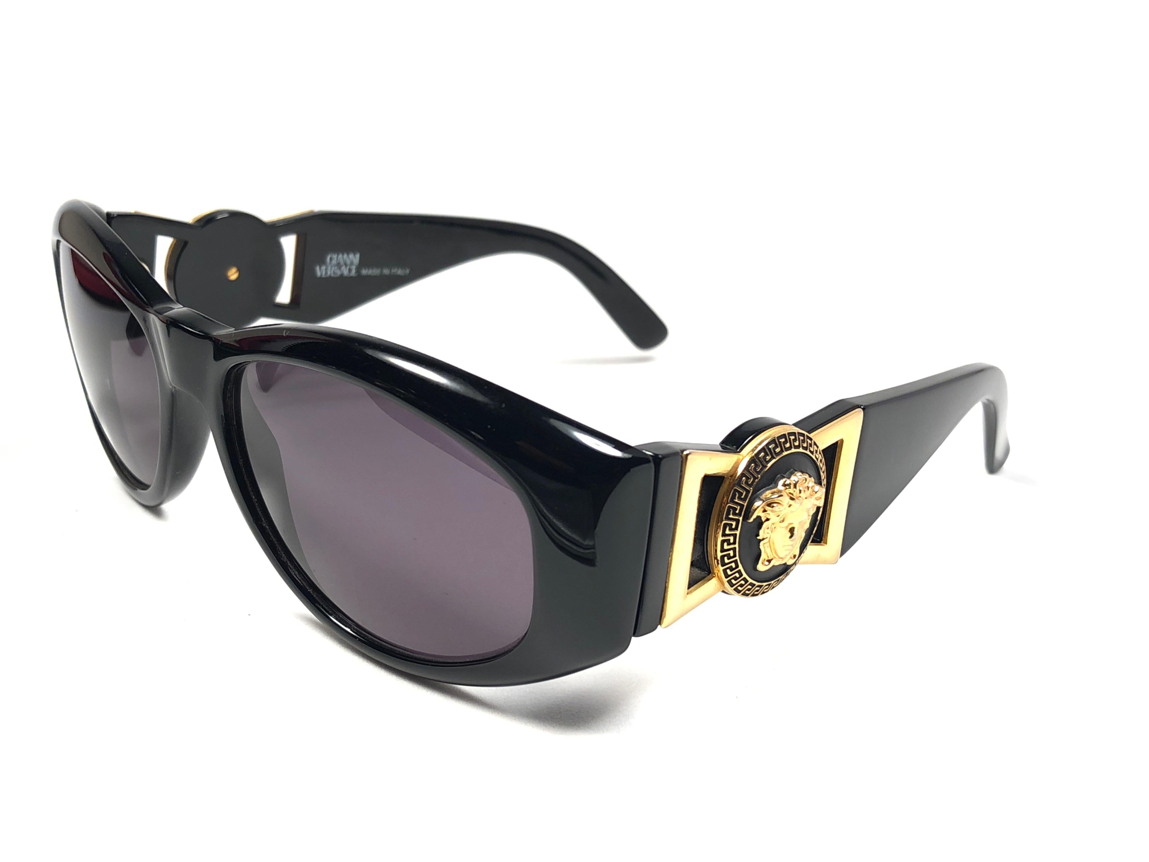 New Vintage Gianni Versace medium BLACK with gold accents frame with medium grey lenses.

New never worn or displayed. Comes with its original Gianni Versace sleeve and cleaning cloth.
This pair could show minor sign of wear due to storage.

Made in