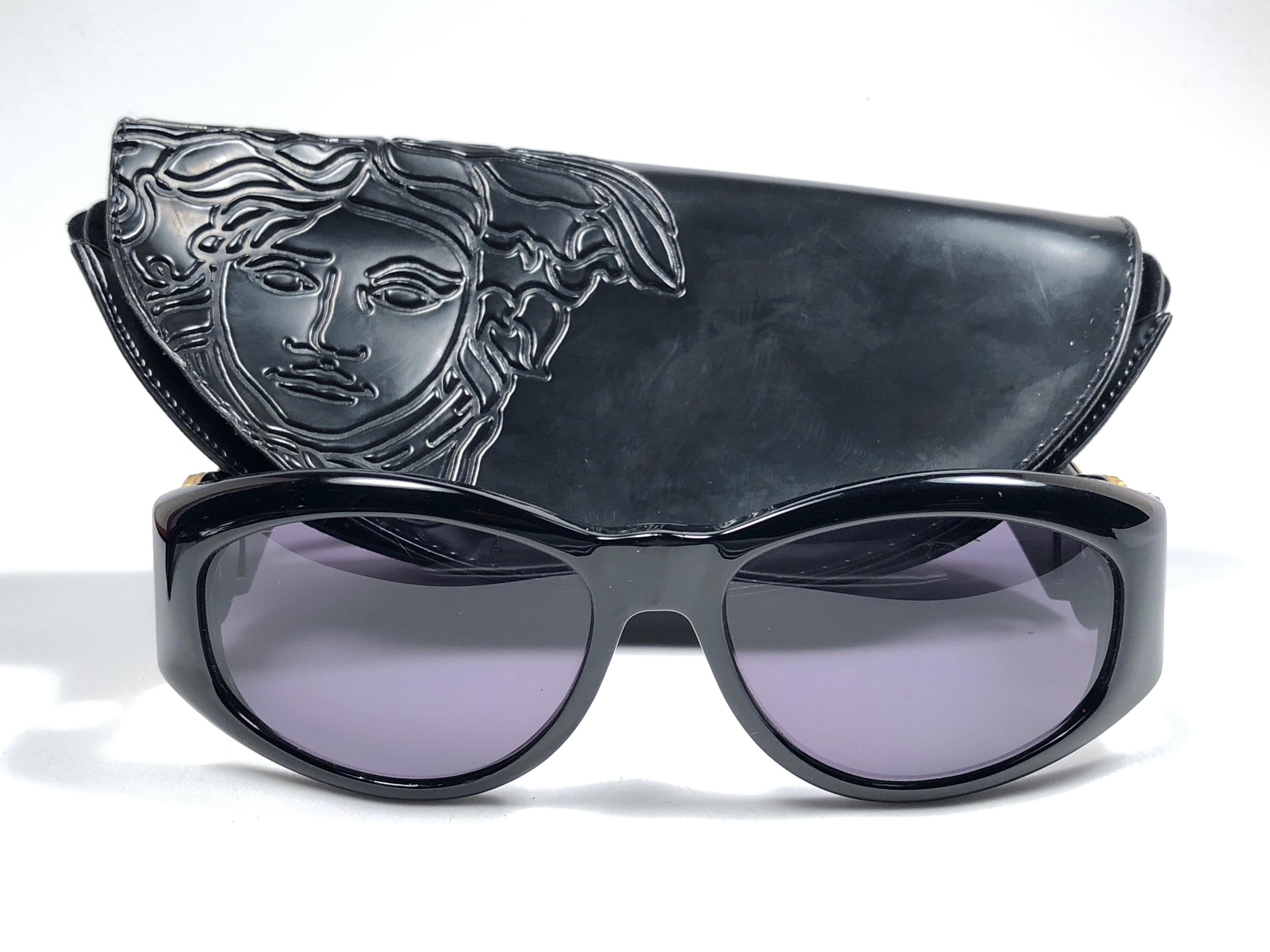 New Vintage Gianni Versace medium BLACK with gold and rhinestones accents frame with medium grey lenses.

New never worn or displayed. Comes with its original Gianni Versace sleeve and cleaning cloth.
This pair could show minor sign of wear due to