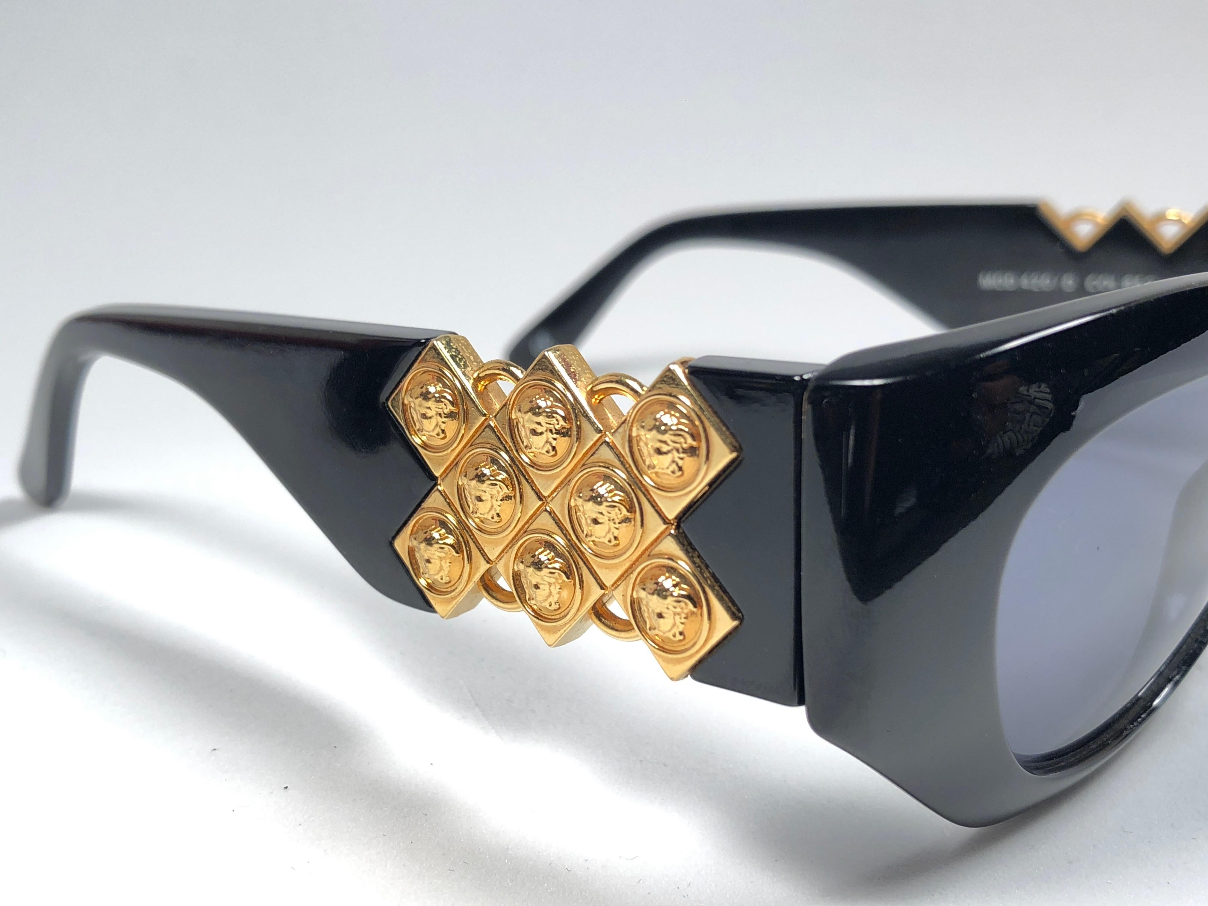 New Vintage Gianni Versace medium BLACK with gold accents frame with medium grey lenses.

New never worn or displayed. Comes with its original Gianni Versace sleeve and cleaning cloth.
This pair could show minor sign of wear due to storage.

Made in