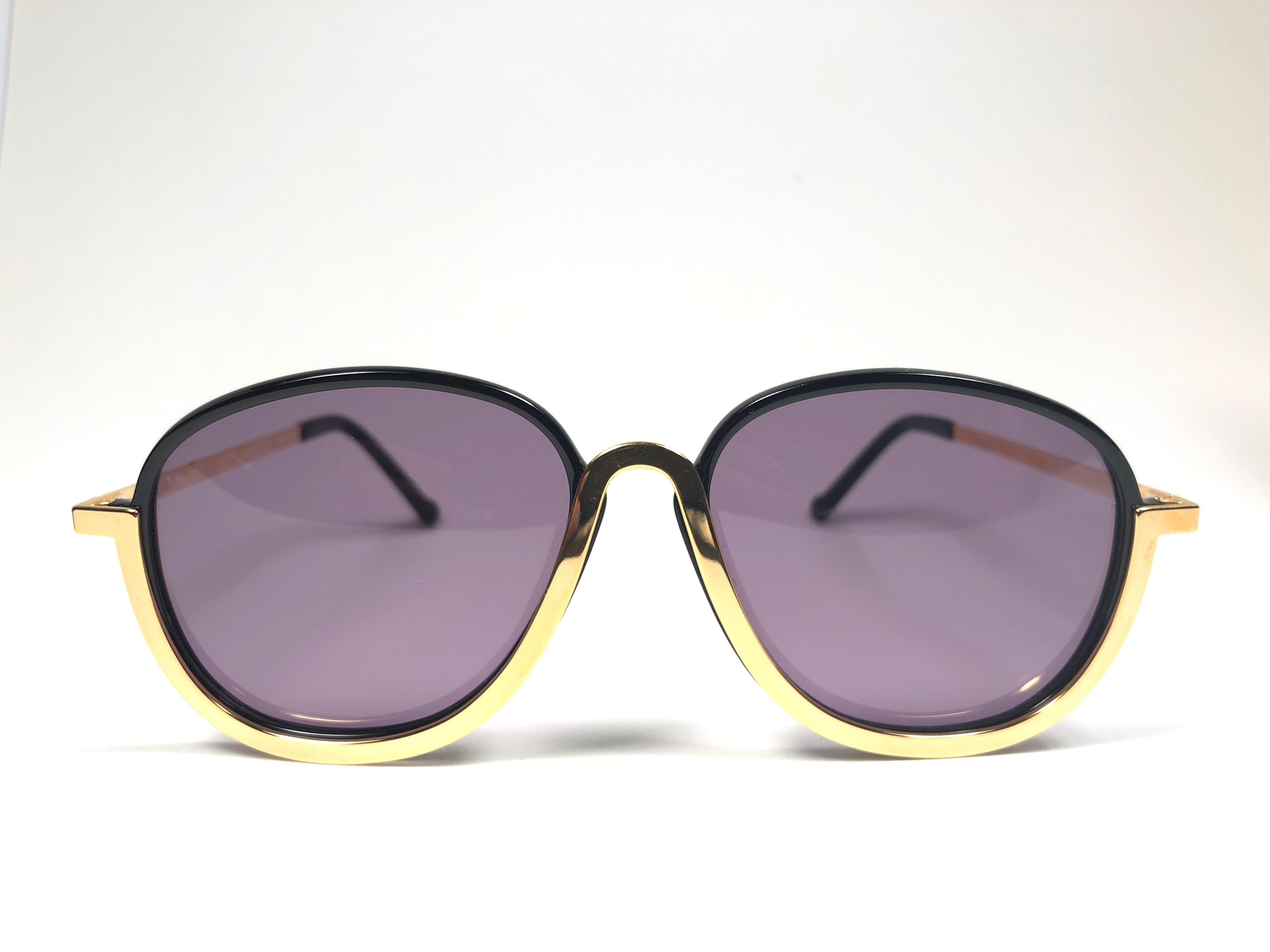 Superb & rare pair of New vintage Christian Lacroix sunglasses.   

Black with delicate gold accents frame holding a pair of spotless lenses.  

New, never worn or displayed. Made in France.

This pair may show minor sign pf wear due to storage.