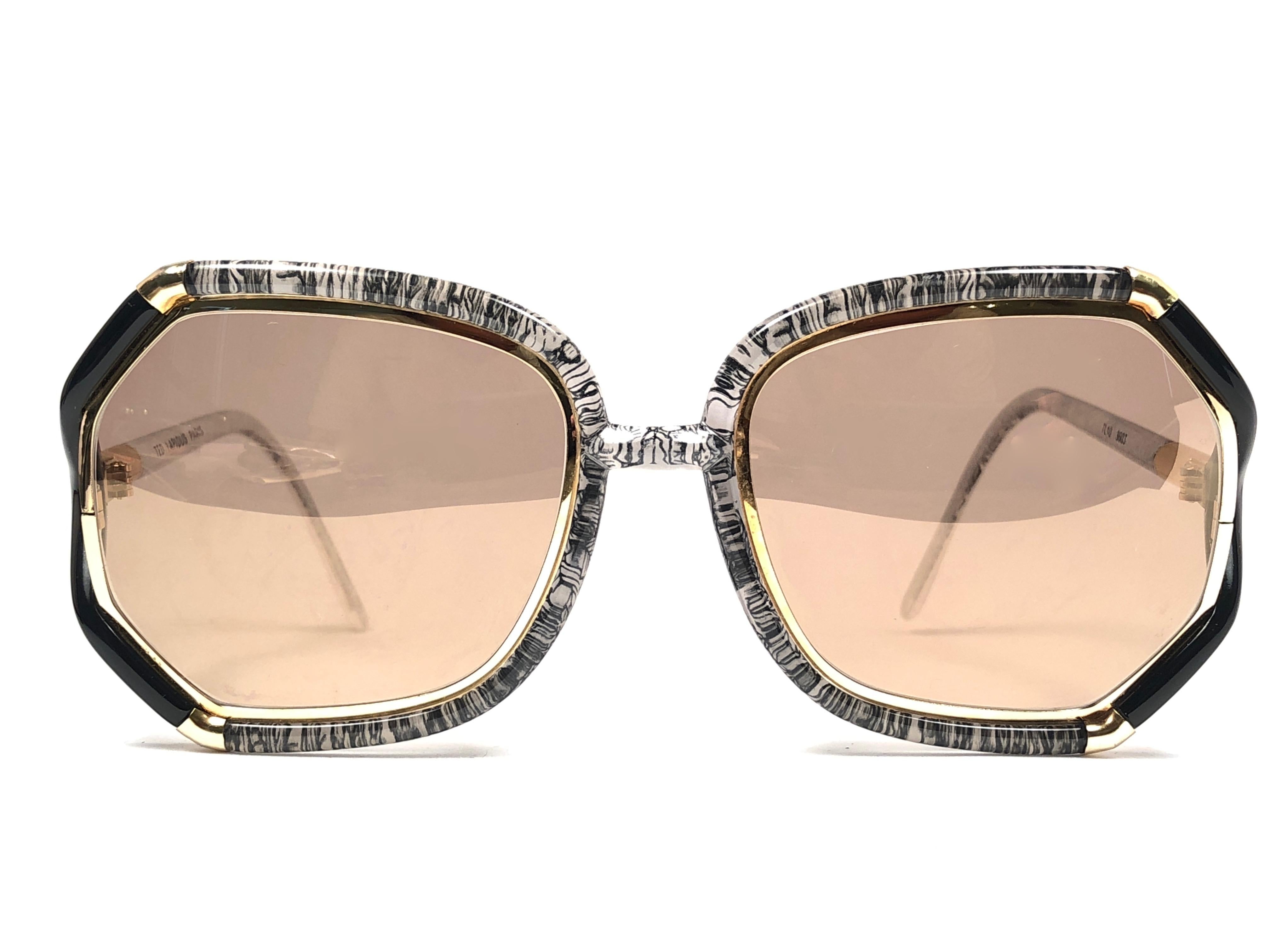 New Vintage Ted Lapidus translucent black & gold frame with spotless lenses.  
Made in Paris.  
Produced and design in 1970's.  
This pair could show minor sign of wear due to storage.
New, never worn or displayed.