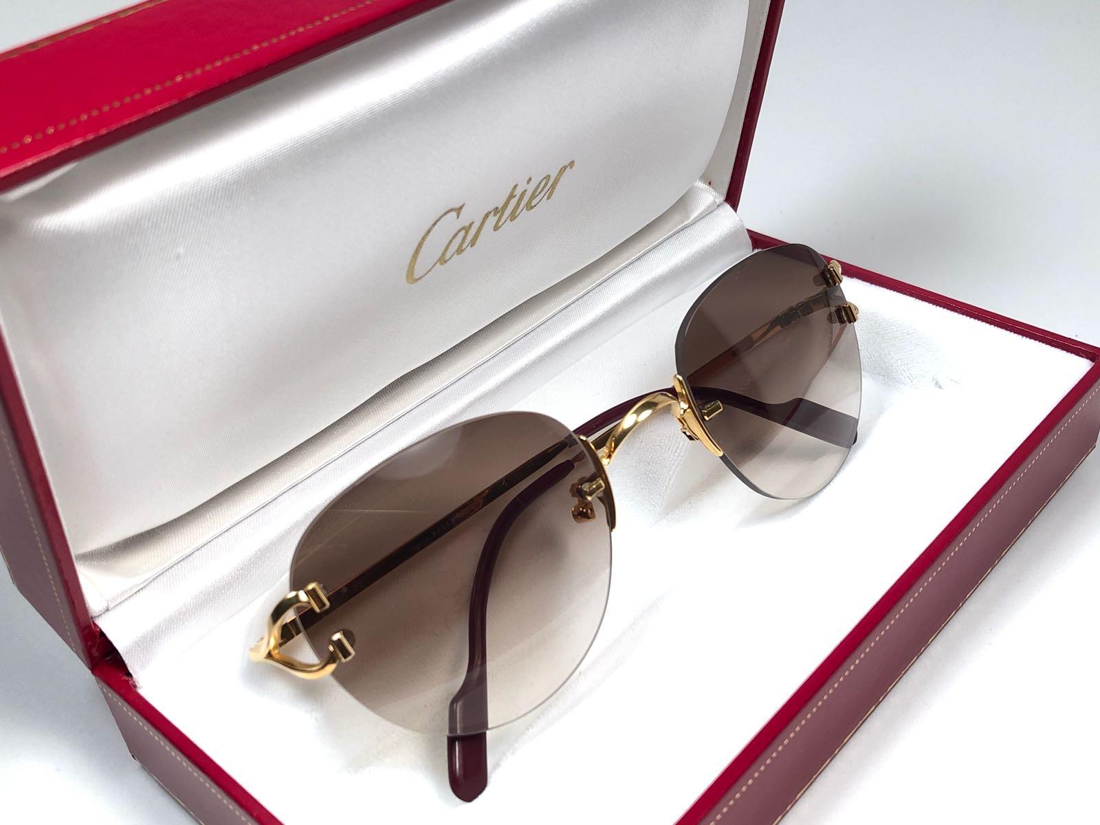 New Cartier Salisbury unique rimless sunglasses with brown gradient (uv protection) lenses.  Frame with the front and sides in gold. All hallmarks. Cartier gold signs on the ear paddles.  These are like a pair of jewels on your nose.  Beautiful