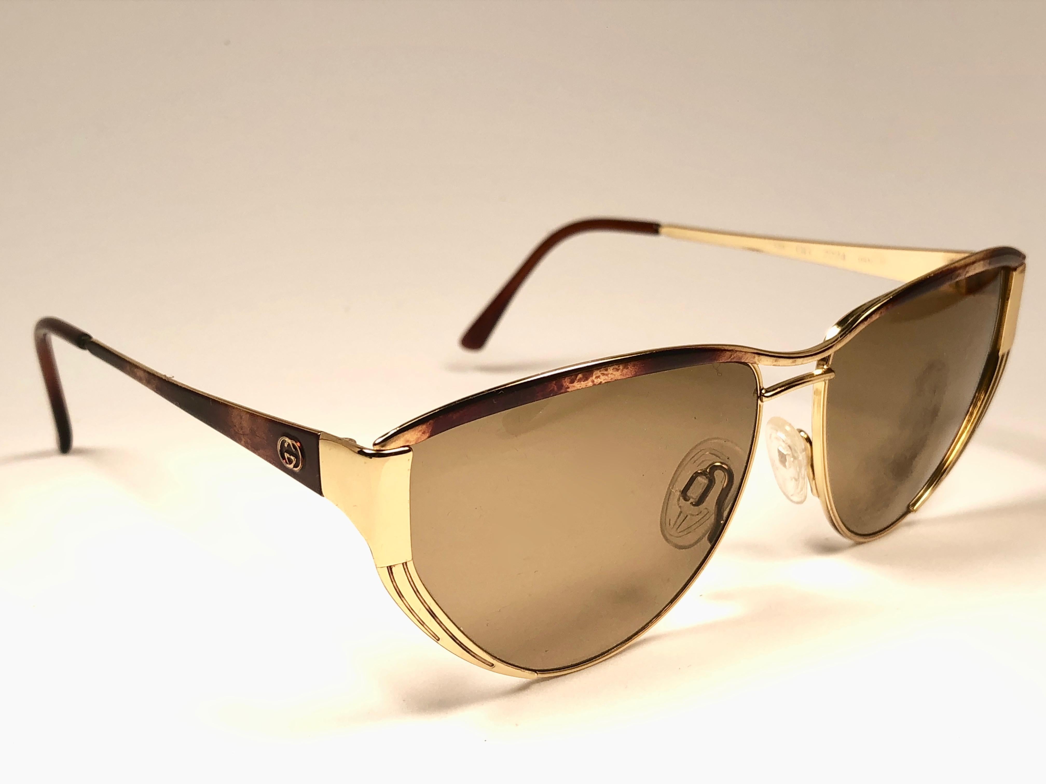 New Vintage Gucci gold and tortoise details frame. 
Spotless lenses.  
New never worn or displayed. This item could show minor sign of wear due to nearly 30 years of storage. Made in Italy.