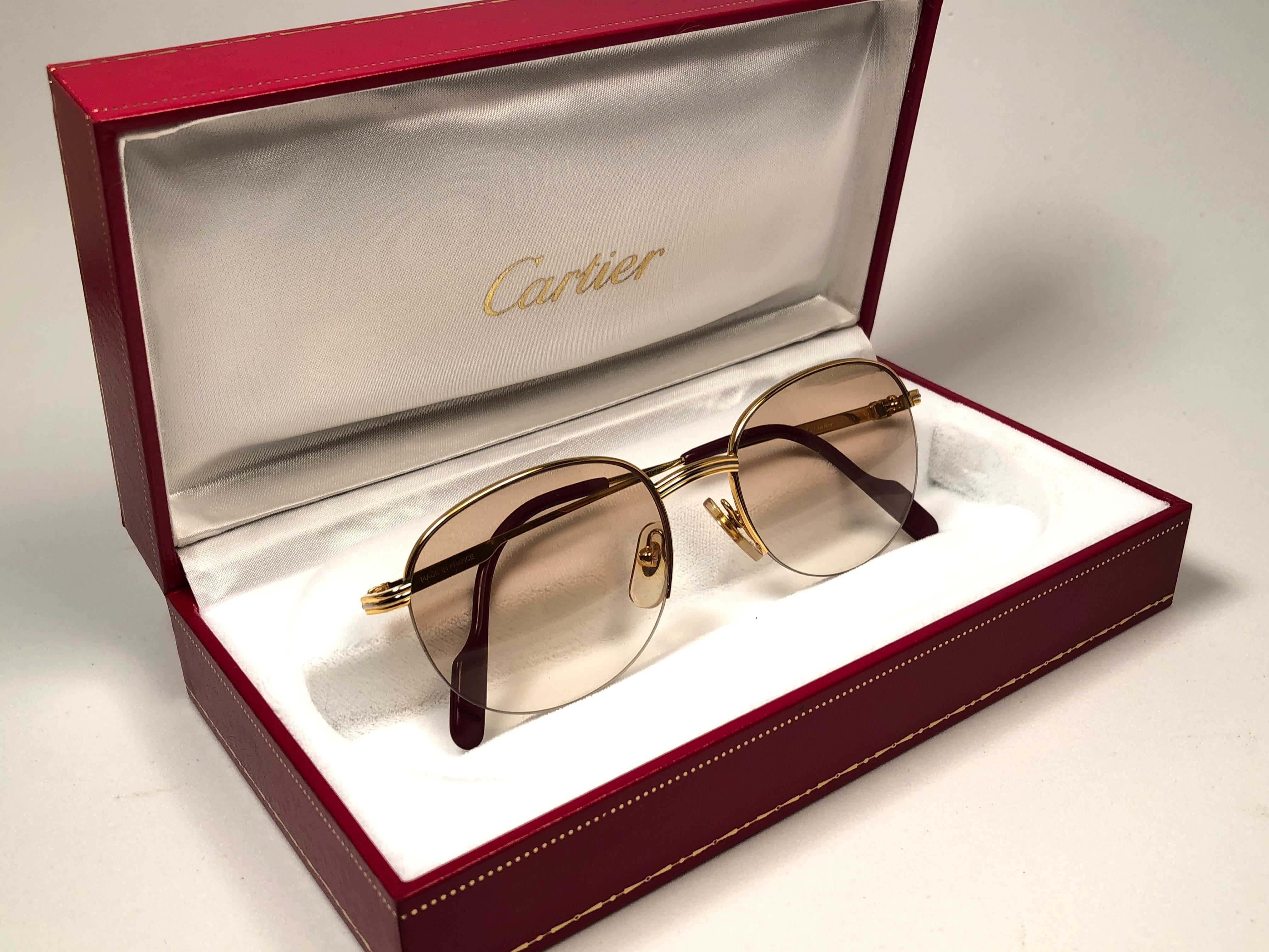 New 1983 Cartier Colisee sunglasses with light gradient (uv protection) lenses. Frame is with the front and sides in yellow and white gold. All hallmarks. Cartier gold signs on the earpaddles. These are like a pair of jewels on your nose with the