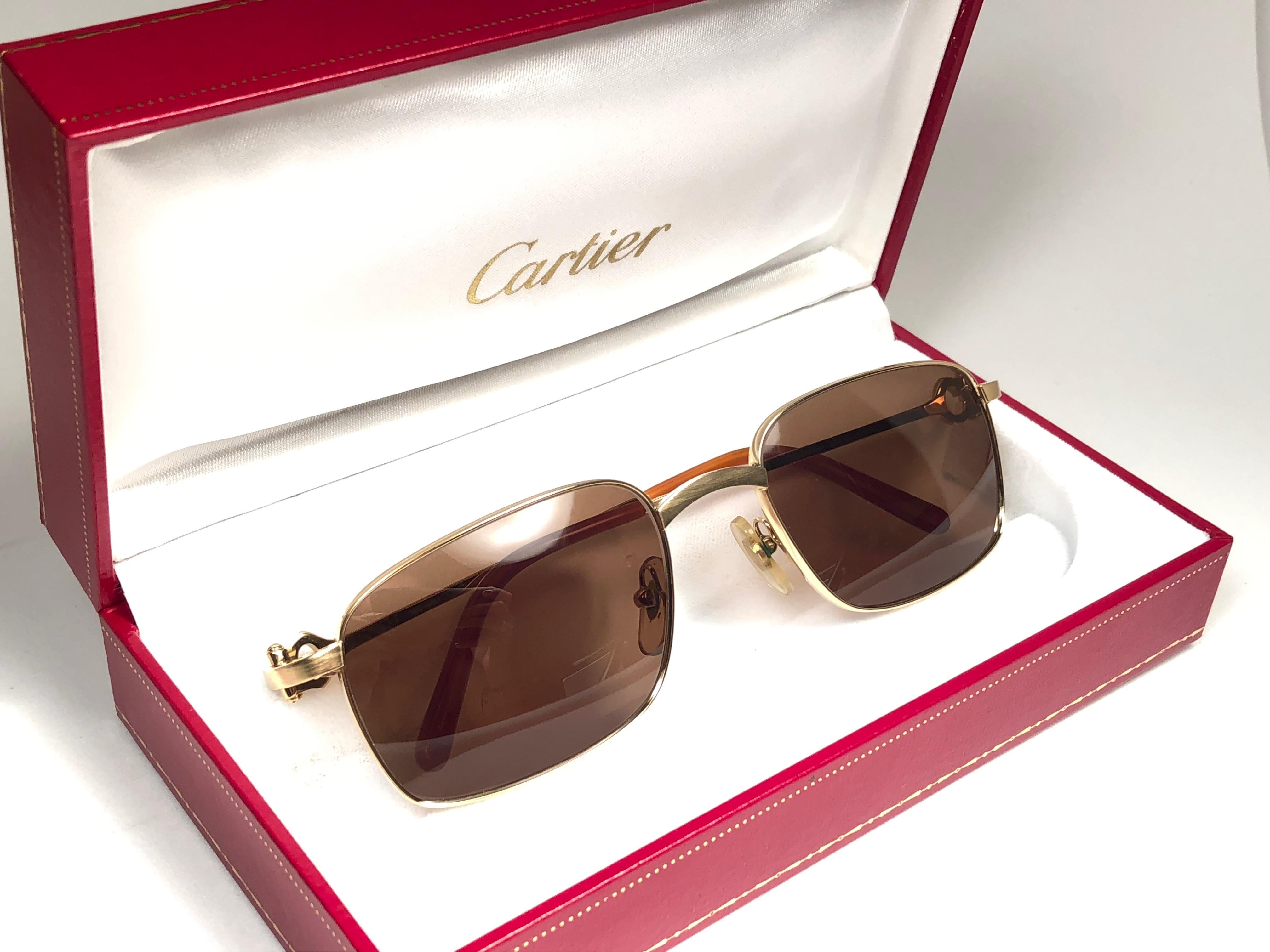 New Cartier Temper brushed gold with brown (uv protection) lenses. 
 All hallmarks. Cartier gold signs on the earpaddles. These are like a pair of jewels on your nose with the 18k gold frame and white gold accents. Beautiful design and a real sign
