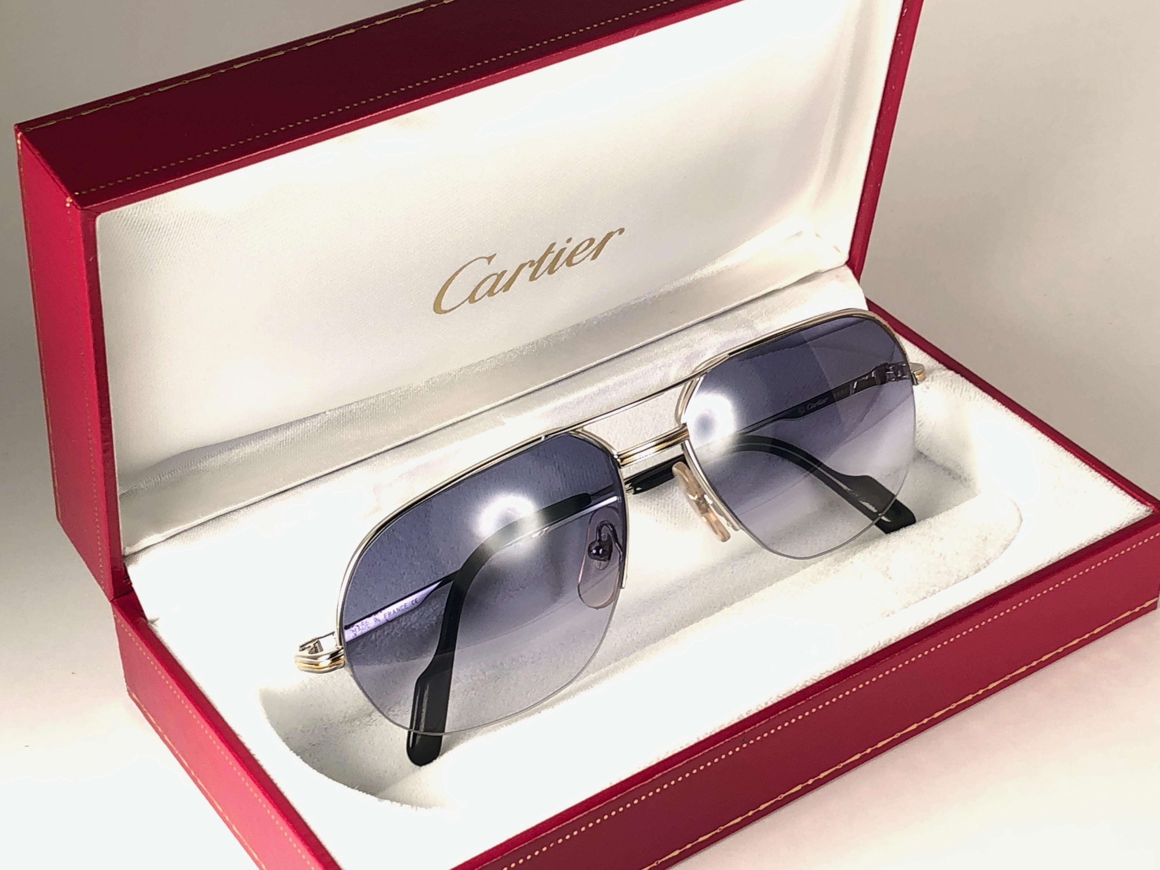 
New 1990 Cartier Tank Orsay Half platine Frame Sunglasses with blue gradient  (uv protection) lenses. 
Frame is with the front and sides in yellow and white gold. All hallmarks. Cartier signs on the ear paddles. These are like a pair of jewels on