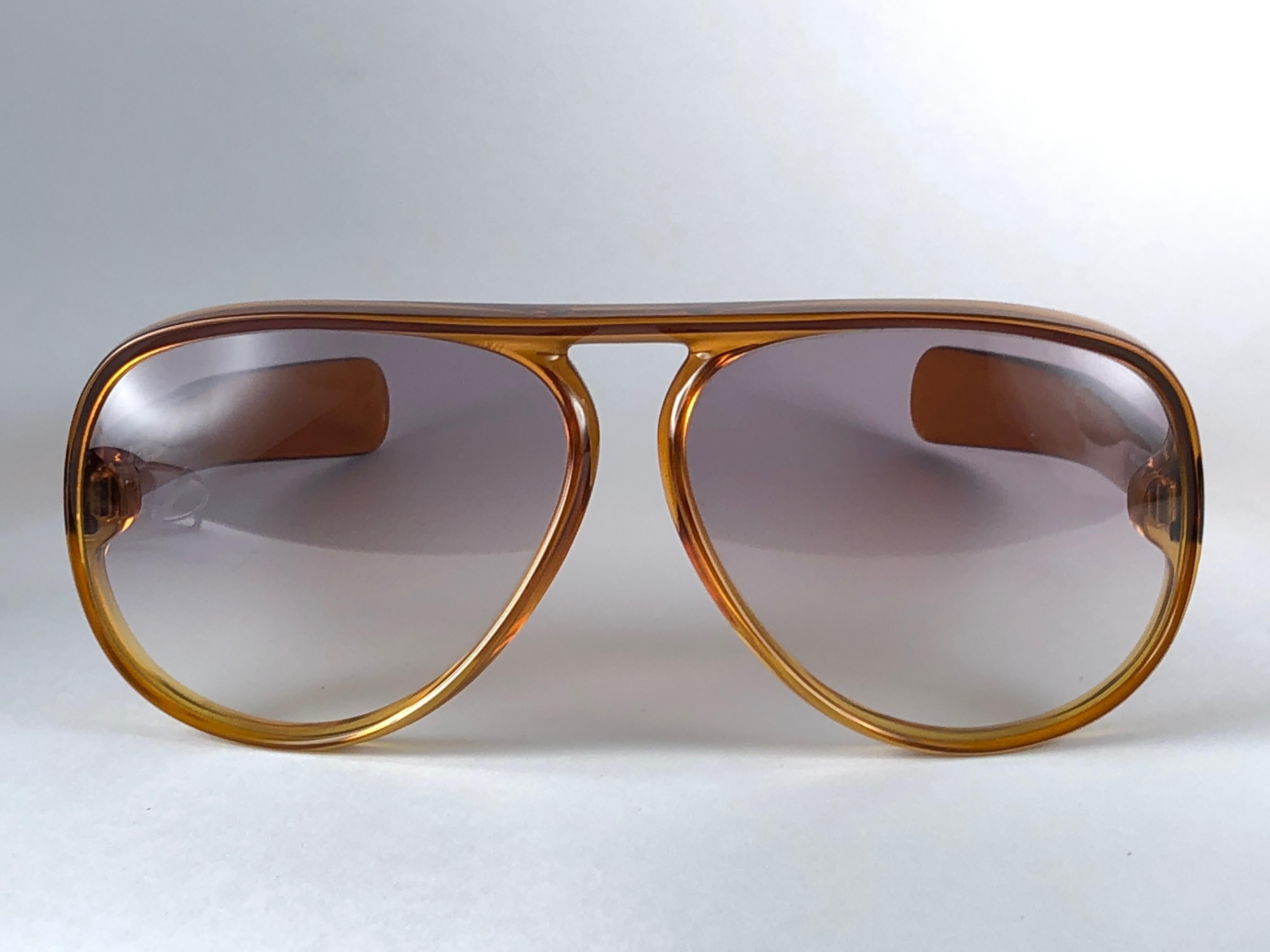 New Vintage Christian Dior D60 J10 sunglasses oversized translucent gradient honey amber aviator with spotless light brown gradient lenses 1970’s.

Made by optyl. 
Manufactured in austria
 
Strong and stunning oversized frame. A must have piece!
