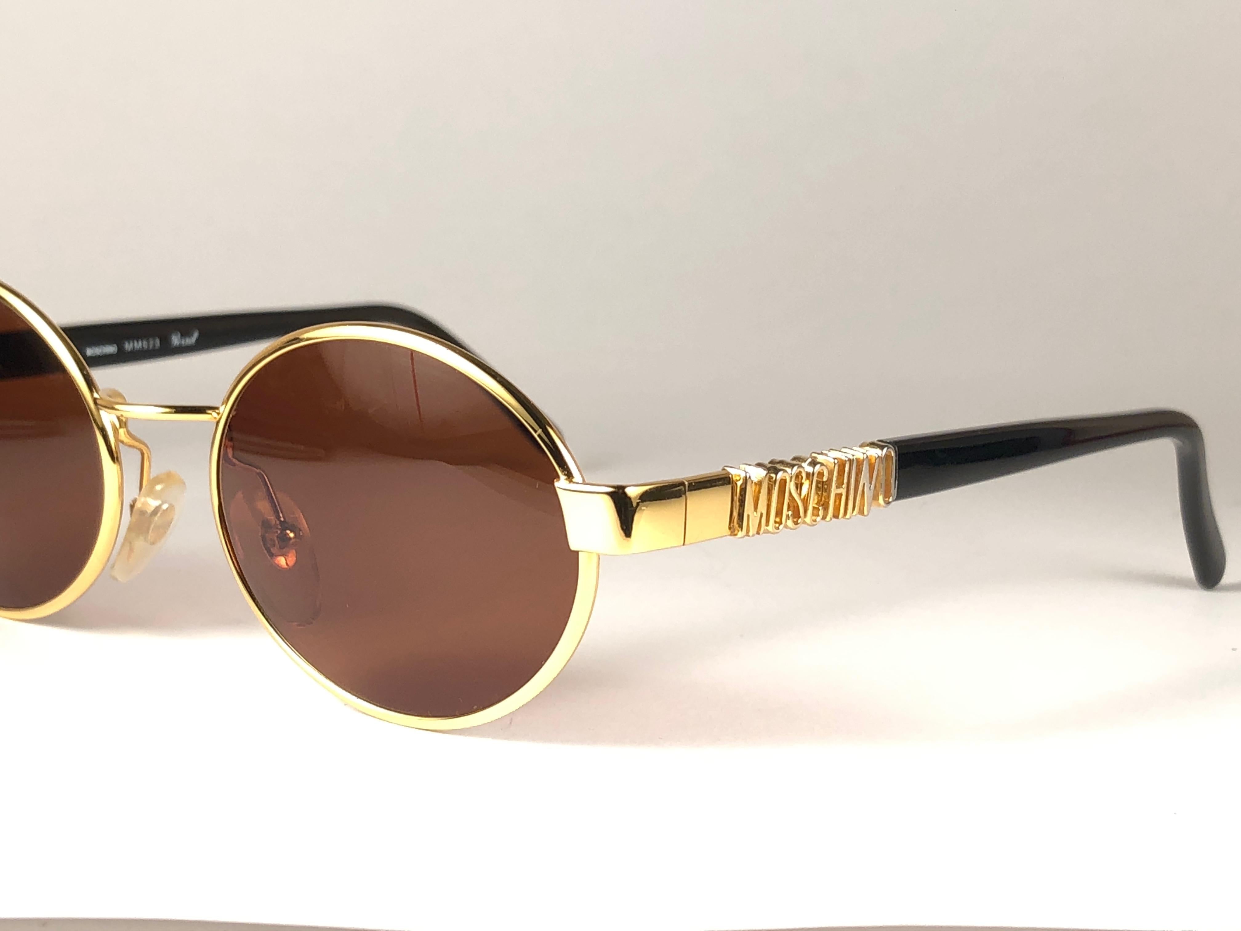 Women's or Men's Mint Vintage Moschino Small Oval Gold 1990 Sunglasses Made in Italy