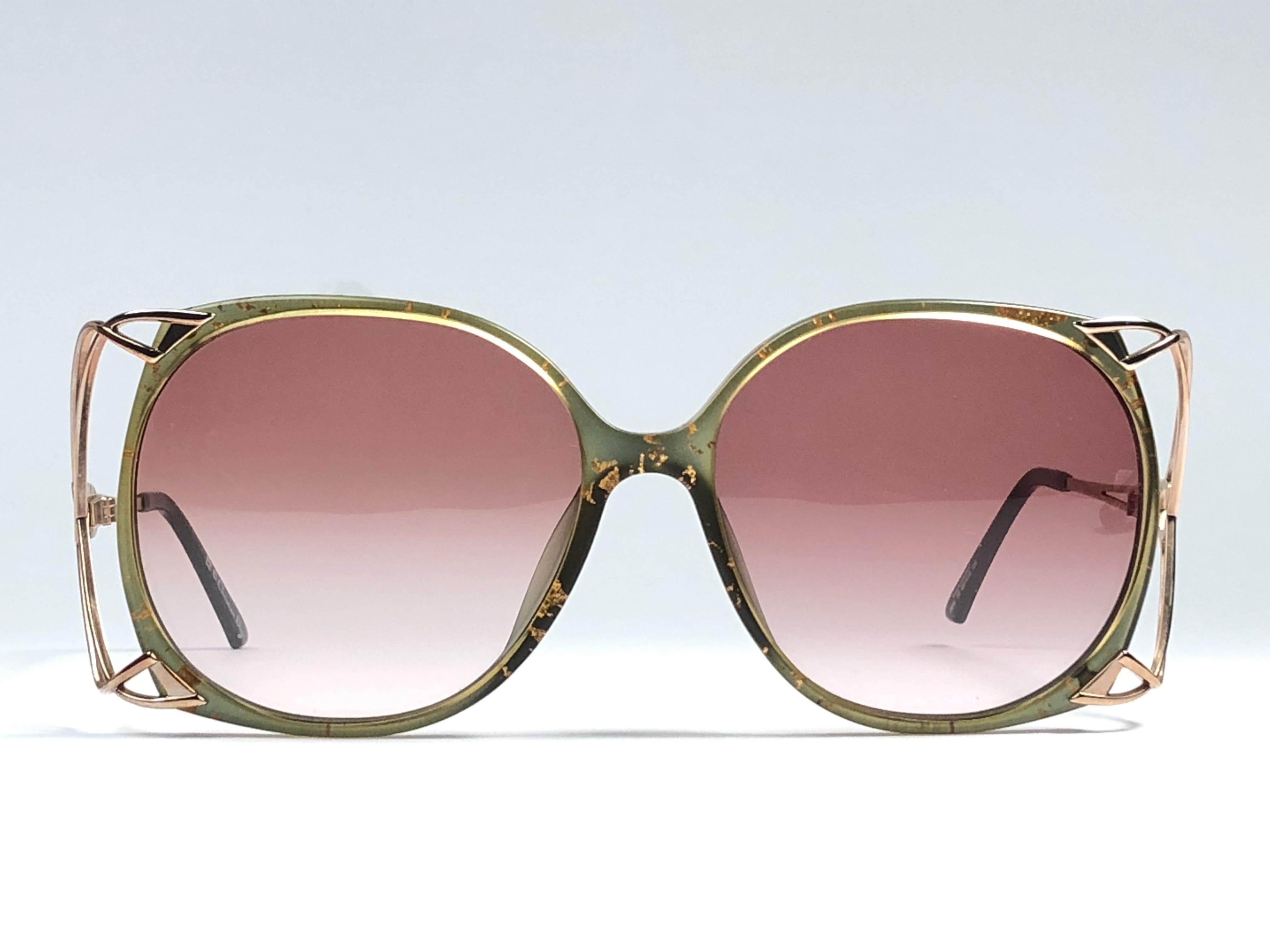 New Vintage Christian Dior 2610 Green frame with gold accented temples. Spotless light rose gradient lenses. 

Made in Germany.
 
Produced and design in 1970's.

New, never worn or displayed. This item may show minor sign of wear due to storage.