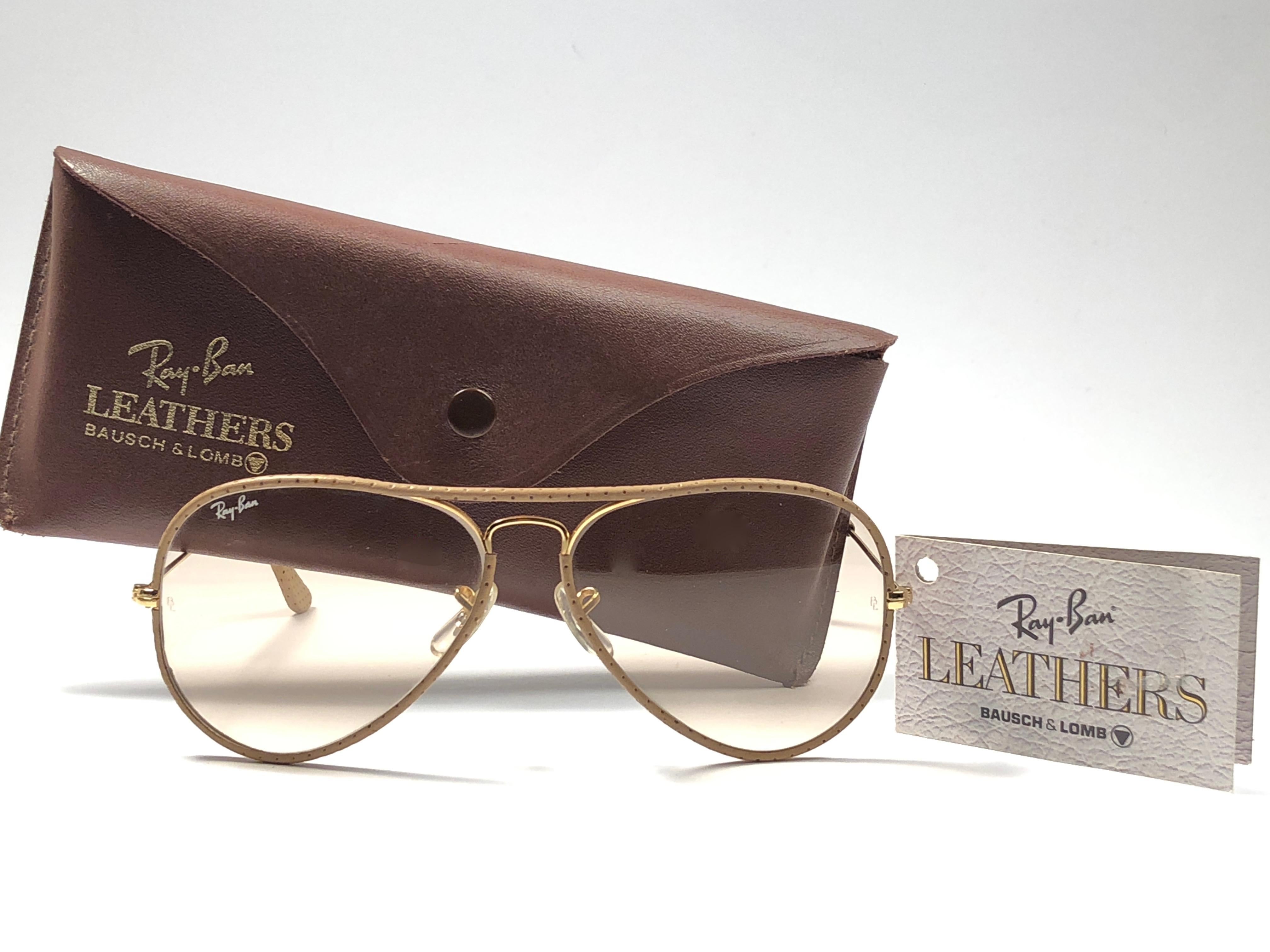 New Vintage Ray Ban Leathers 58mm in tan perforated leather with gold metal combination frame sporting brown changeable lenses.

Comes with its original Ray Ban B&L case with minor sign of wear due to storage. 
Rare and hard to find in this new,