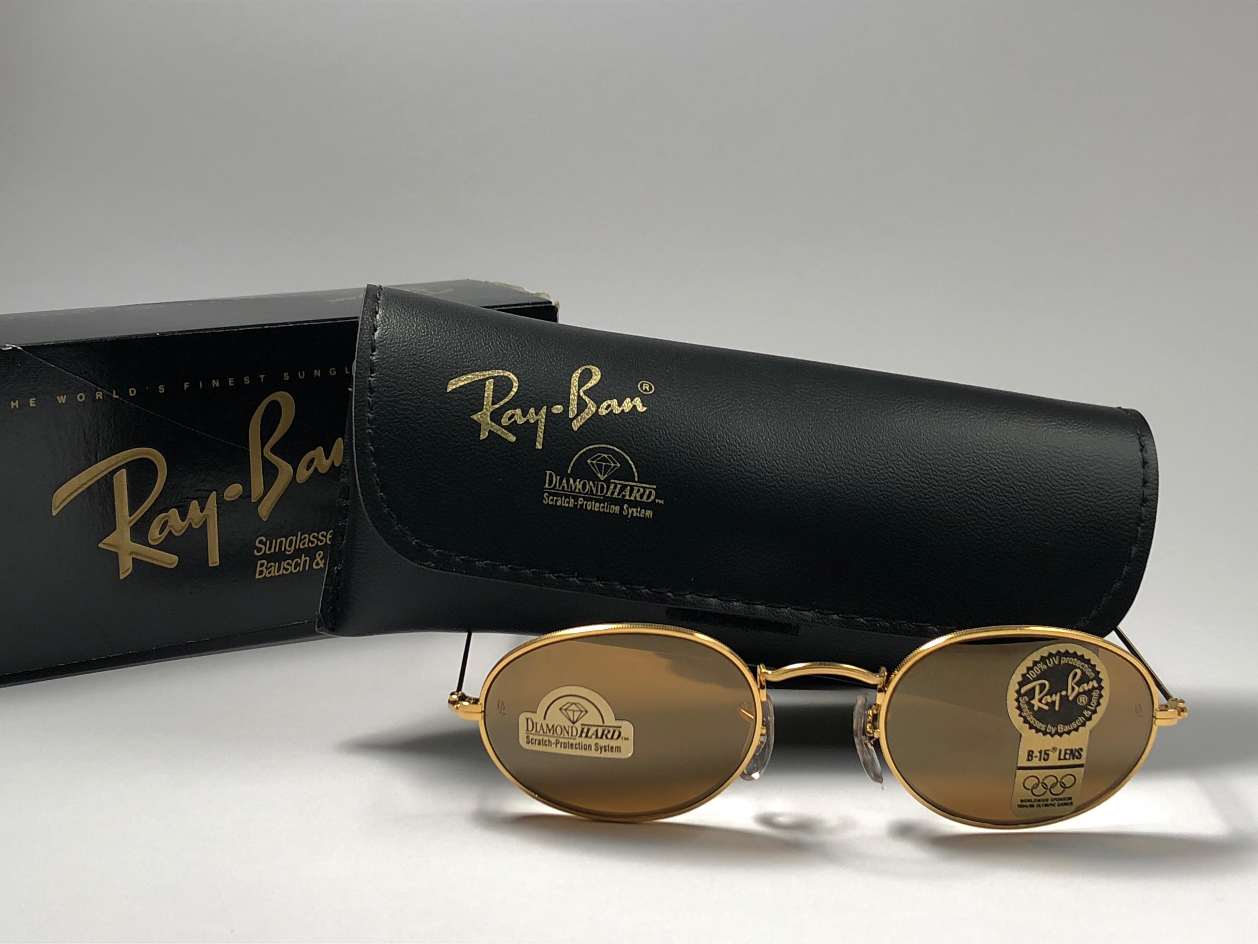 New Vintage Ray Ban Oval Gold frame holding a pair of rare Ray Ban B&L Diamond Hard lenses with logo. Comes with its original Ray Ban B&L case, booklet, carton box and cleaning cloth.
This piece may show minor sign of wear due to storage.  
A seldom