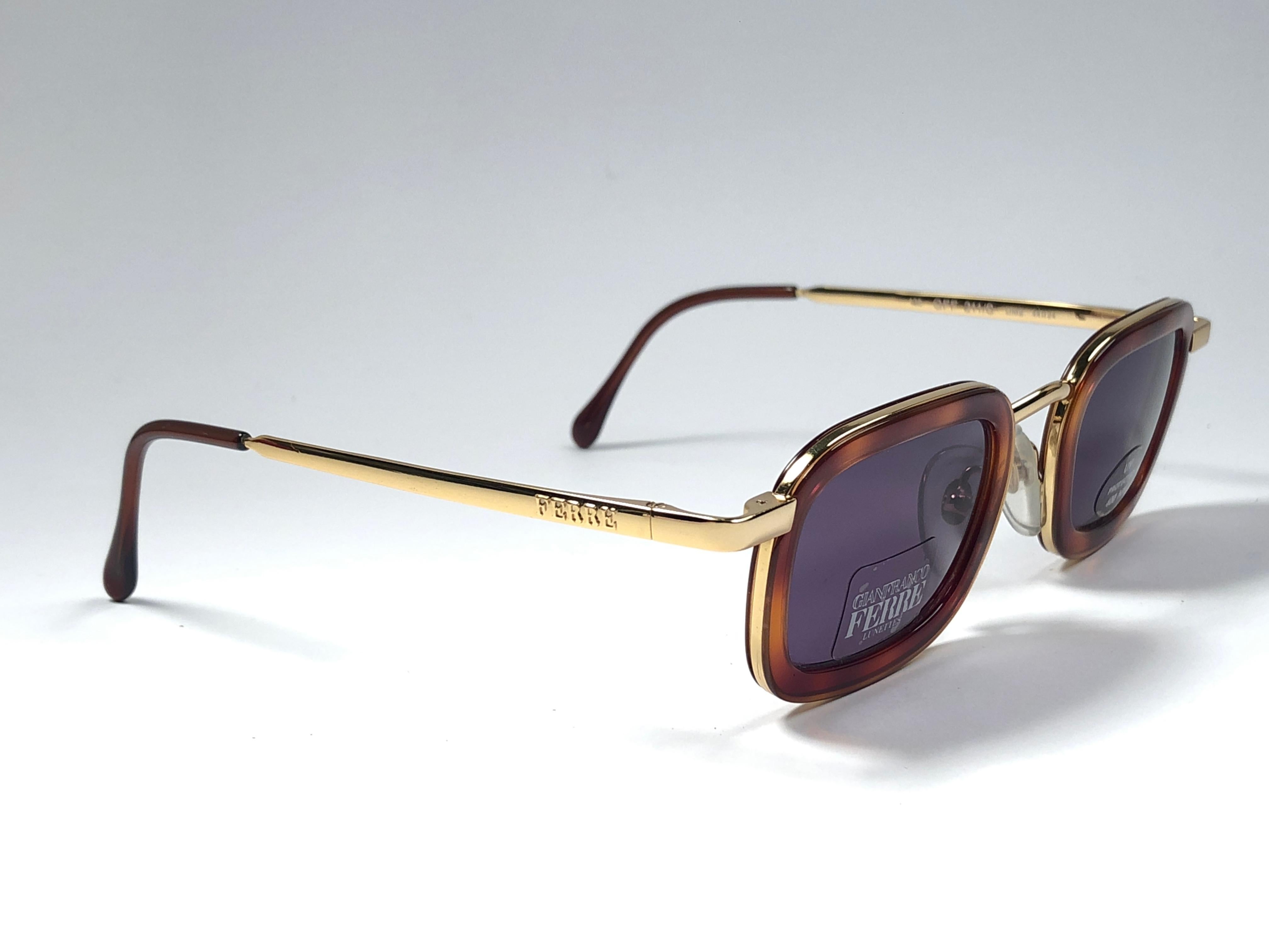 New vintage Gianfranco Ferre sunglasses.    

Gold and tortoise details frame holding a pair of spotless grey lenses.   

New, never worn or displayed. 

 Made in Italy.