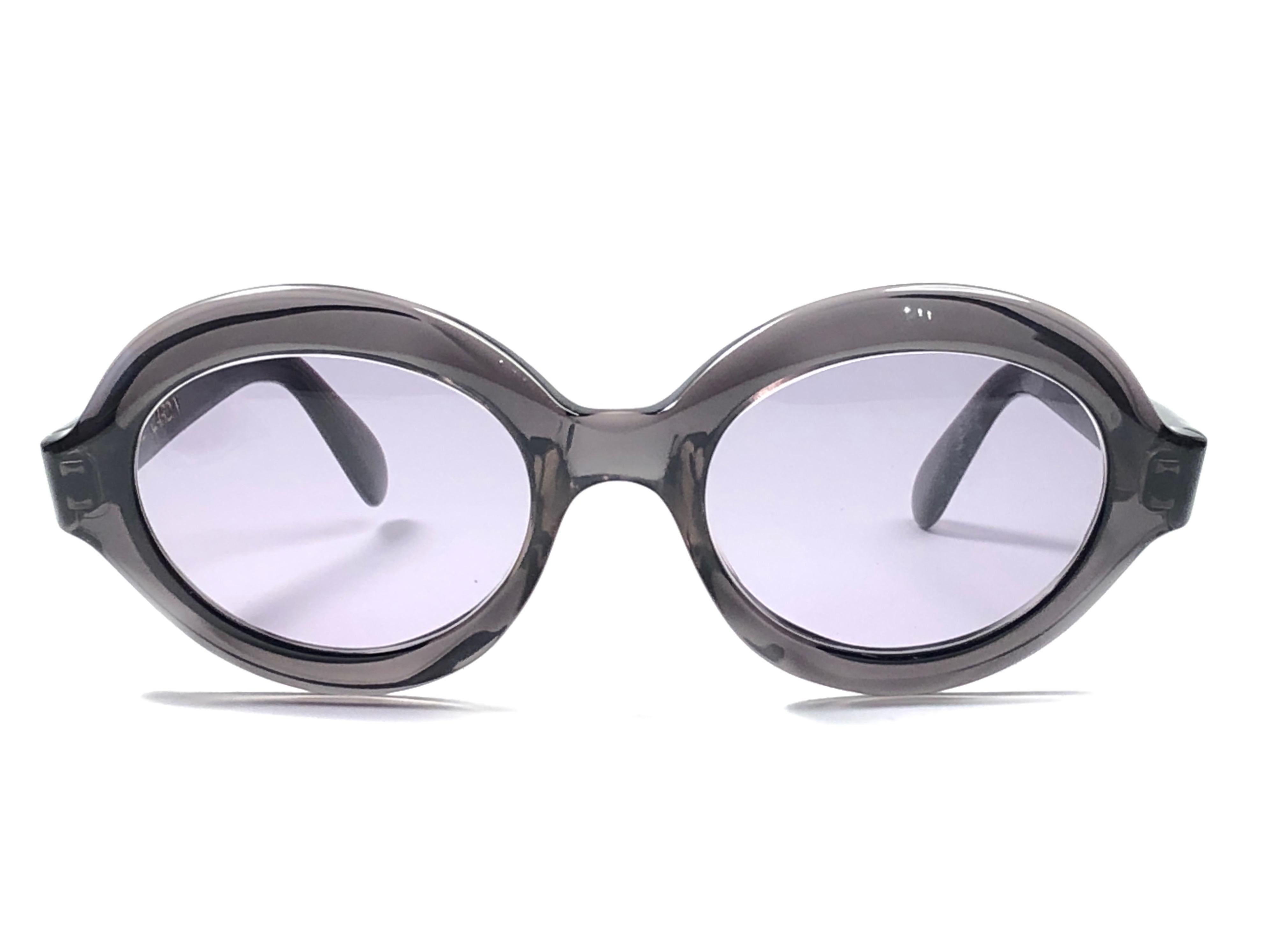 Vintage New Pierre Cardin medium round translucent charcoal frame with grey lenses. 

New, never used or displayed this pair of vintage Pierre Cardin is a rare and sought after piece not to miss out!