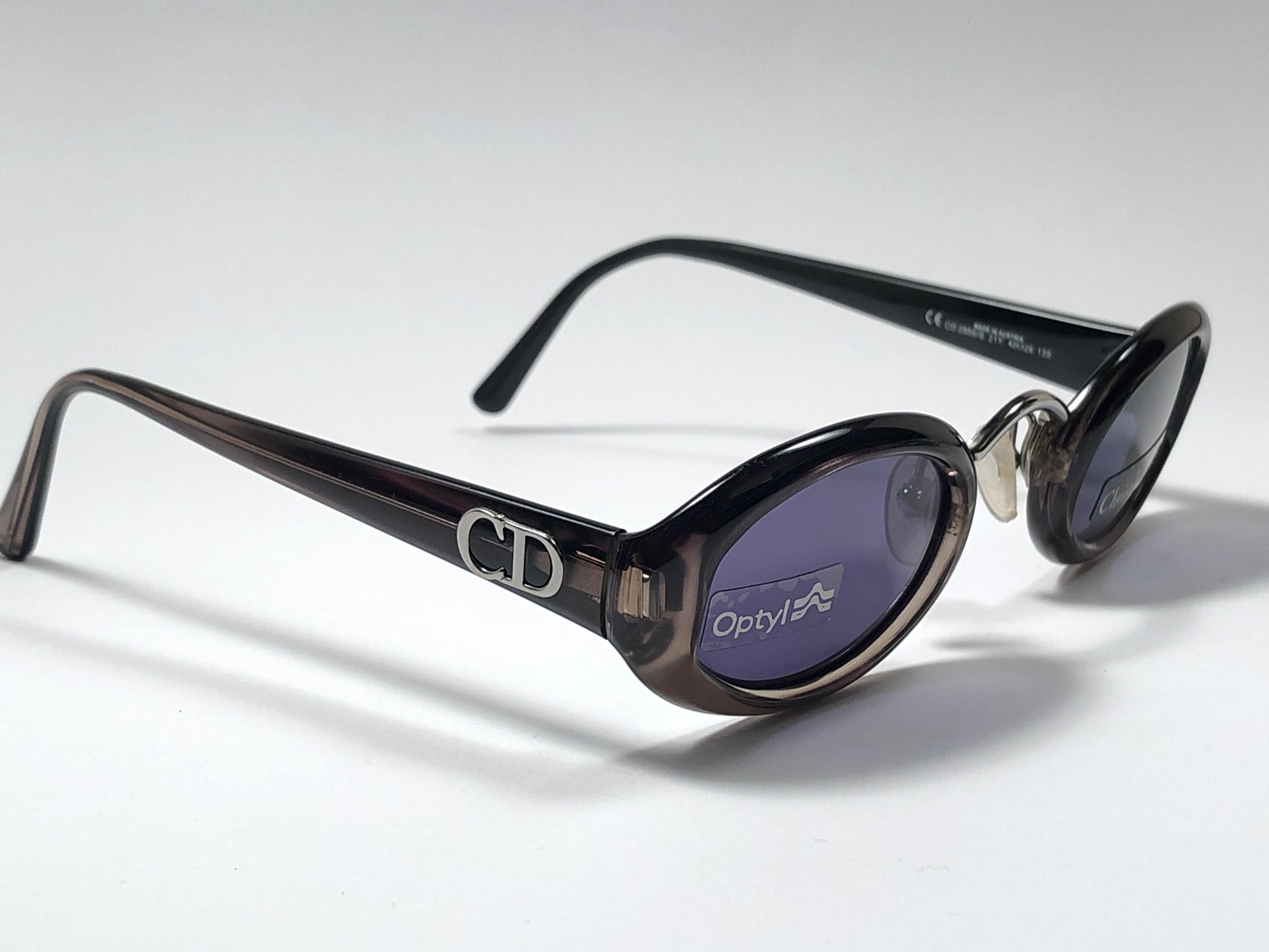 New Vintage Christian Dior 2956 Translucent small oval frame sporting grey lenses. 

Made in Germany.
 
Produced and design in 1980's.

New, never worn or displayed. This piece could show minor sign of wear due to storage.