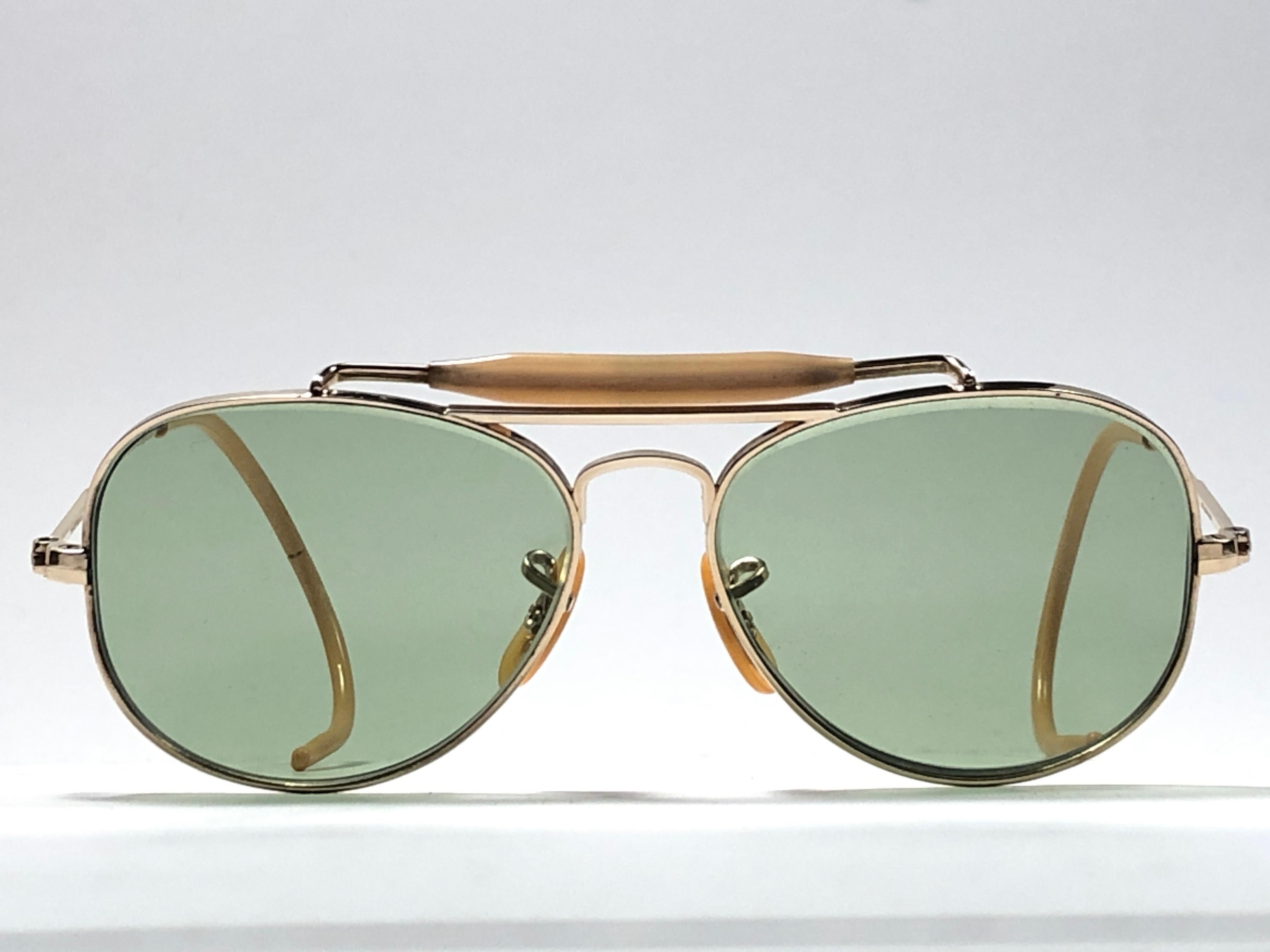 New Super special 1940's vintage Ray Ban Oudoorsmas Aviator 12K gold filled frame with light green lenses.
The smallest size available, suitable for children.  
This piece is a seldom piece. A real piece in sunglasses history.