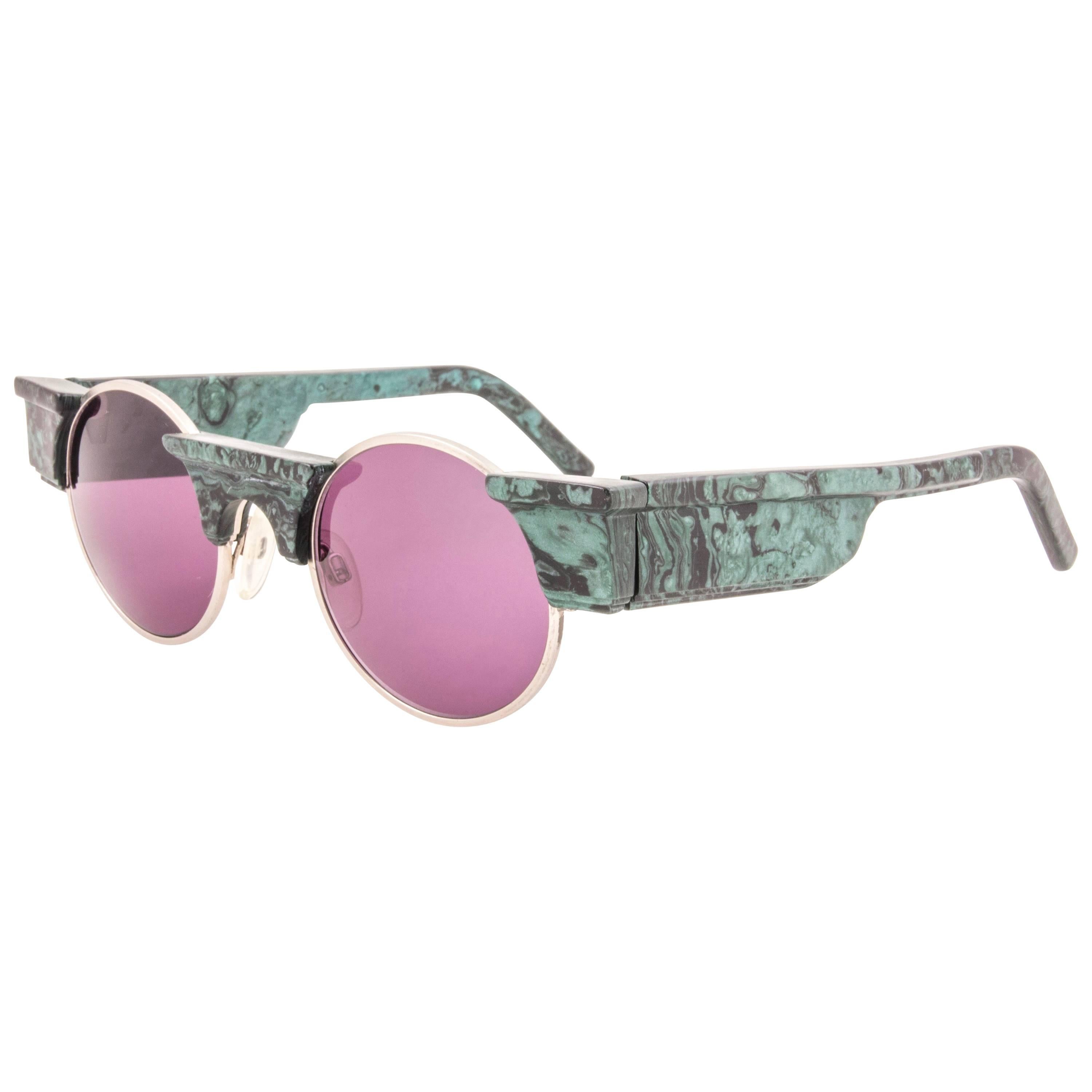 
Striking pair of vintage Karl Lagerfeld Round green marbled sunglasses sporting a spotless pair of rose lenses. Superb design emulating ancient greek architecture. 
 
Although it has never ever been used or displayed could show minor sign of wear