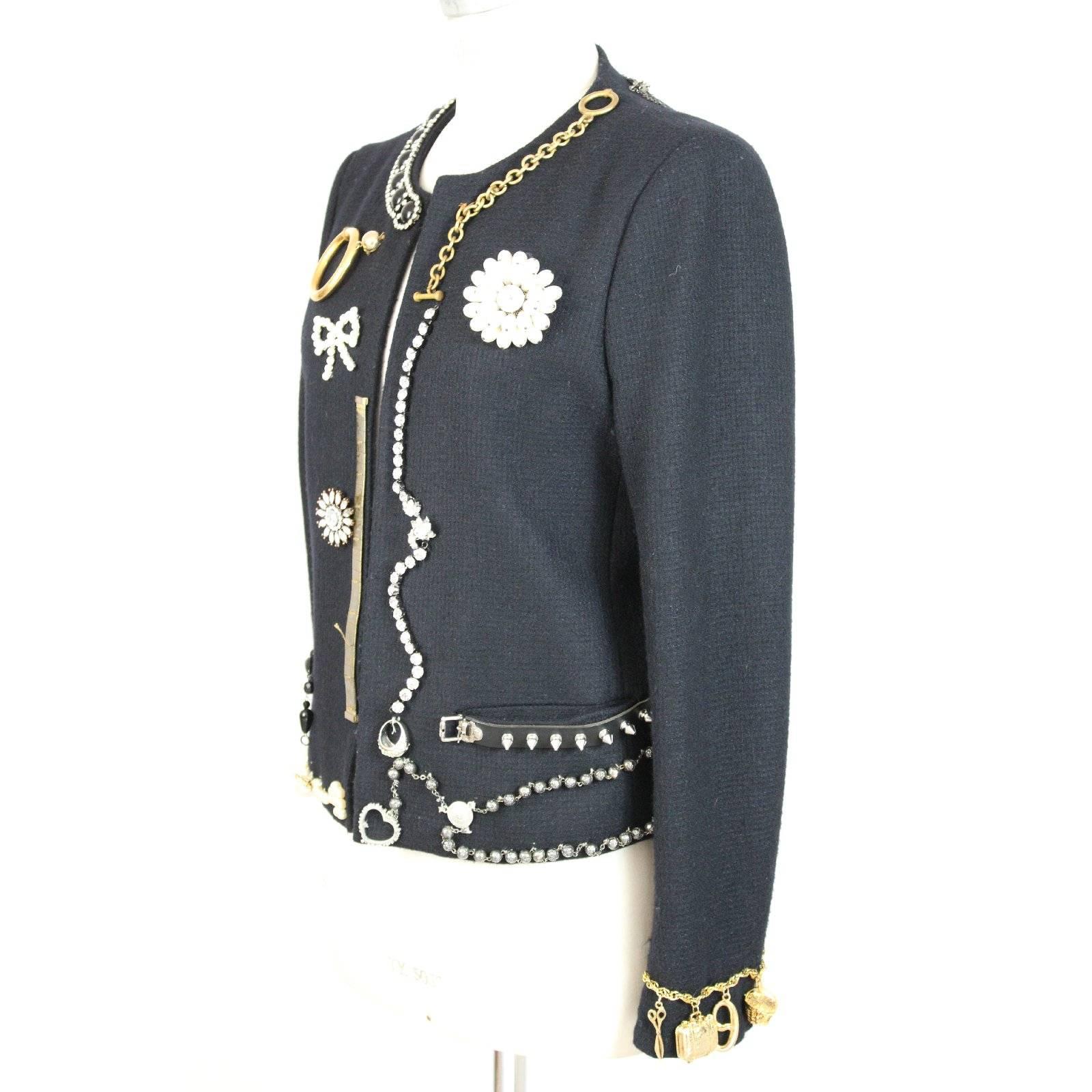 Moschino rare vintage blue jacket. The jacket has various applications. Chains, necklaces, jewelry, rings and pearls make this jacket unique. An artwork made in italy. These jackets were produced in limited edition. The fabric is 100% virgin wool.