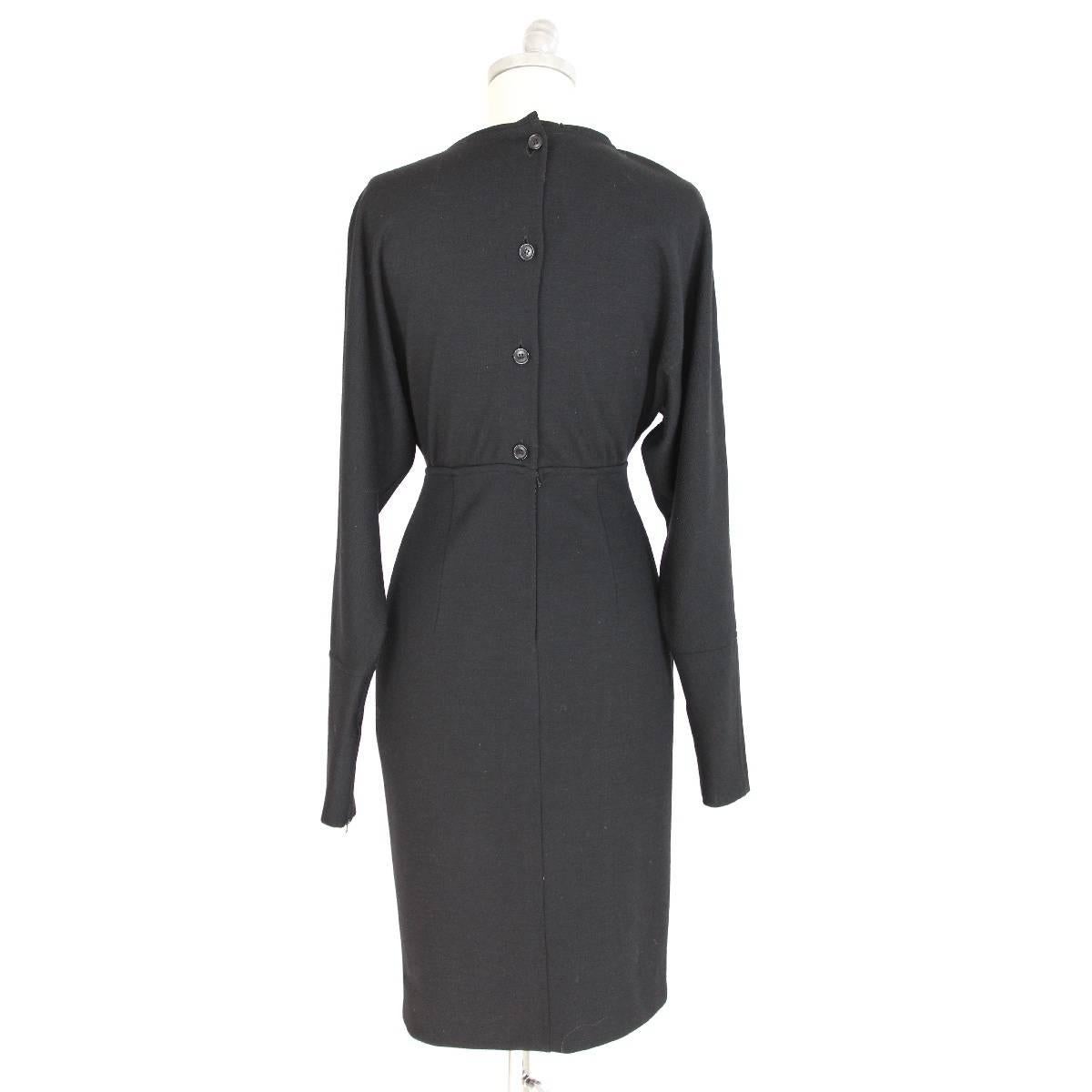 Gucci black dress in vintage wool, knee length, batwing sleeves, two side pockets, back closure with buttons, excellent condition, rare 1980s label.

Size 40 (IT); 6 US; 8 UK

Measures
Shoulder: 40 cm
Bust / chest: 44 cm
Sleeve: 64 cm
Length: 64