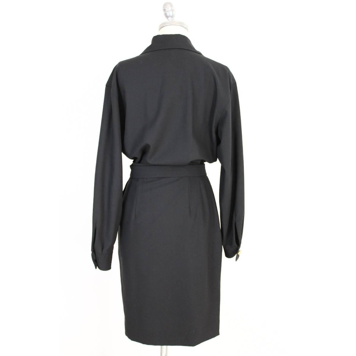 Salvatore Ferragamo black wool cocktail dress, new with label. Long sleeve dress, wallet skirt. Buttons gold color jewel. Waist belt with golden medallion with logo. Silk lined skirt. Two pockets on the sides. New with label. There are spare