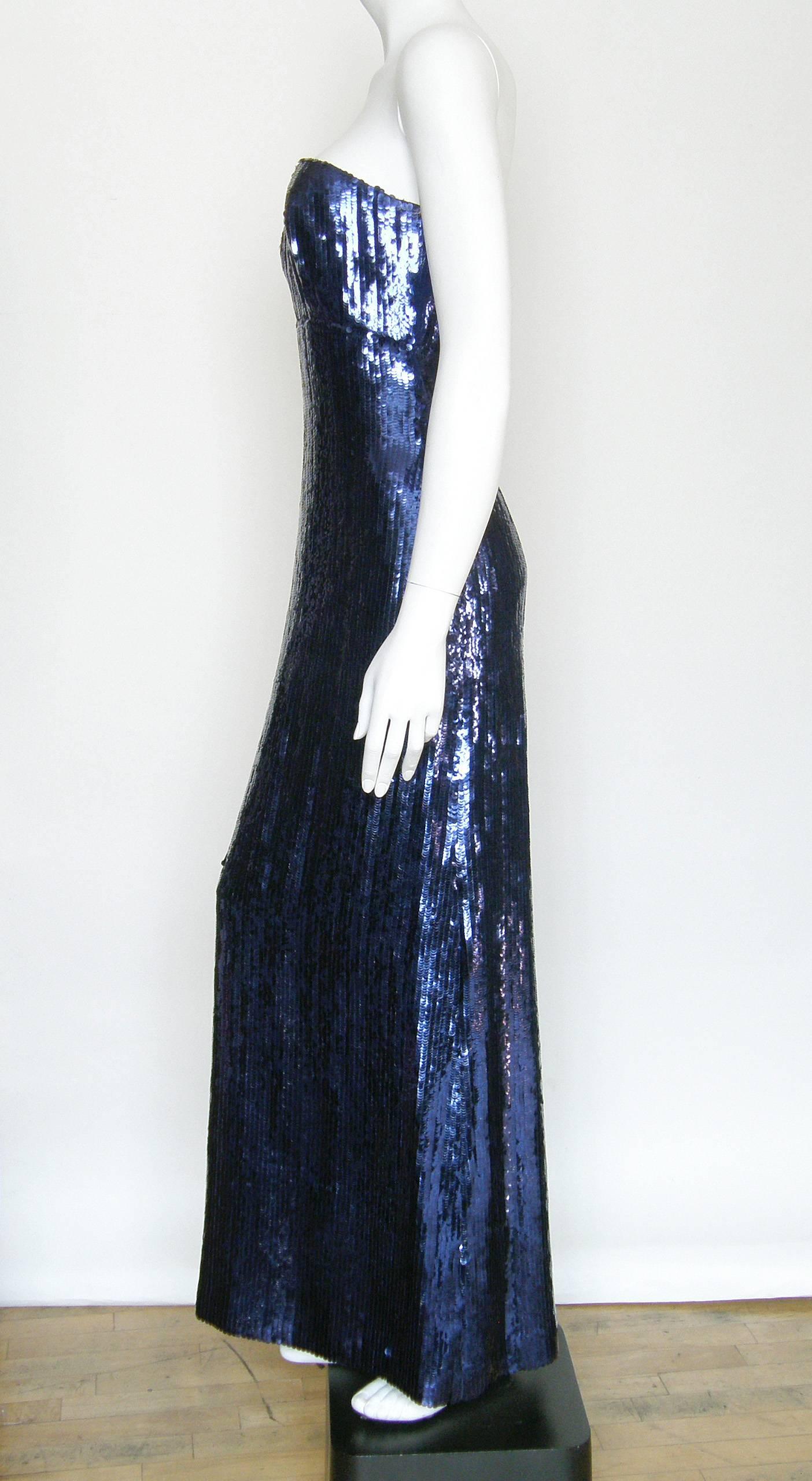 This knock out,  floor length, strapless column dress by Matty Talmack is fully encrusted with blue sequins. It's beautifully constructed with (metal) boned bodice and additional floating/hanging bones between the breasts for extra structure. This
