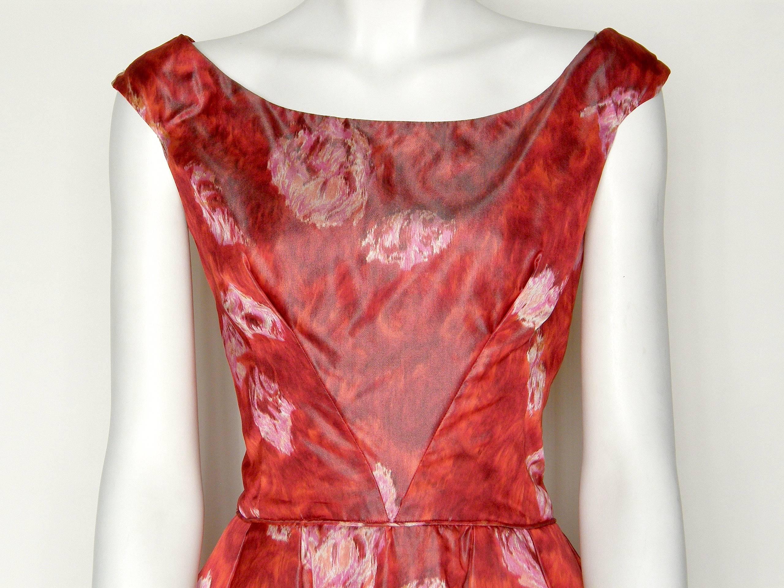 This chic cocktail dress has deep red silk fabric with a painterly, watercolor style roses print. The fabric 