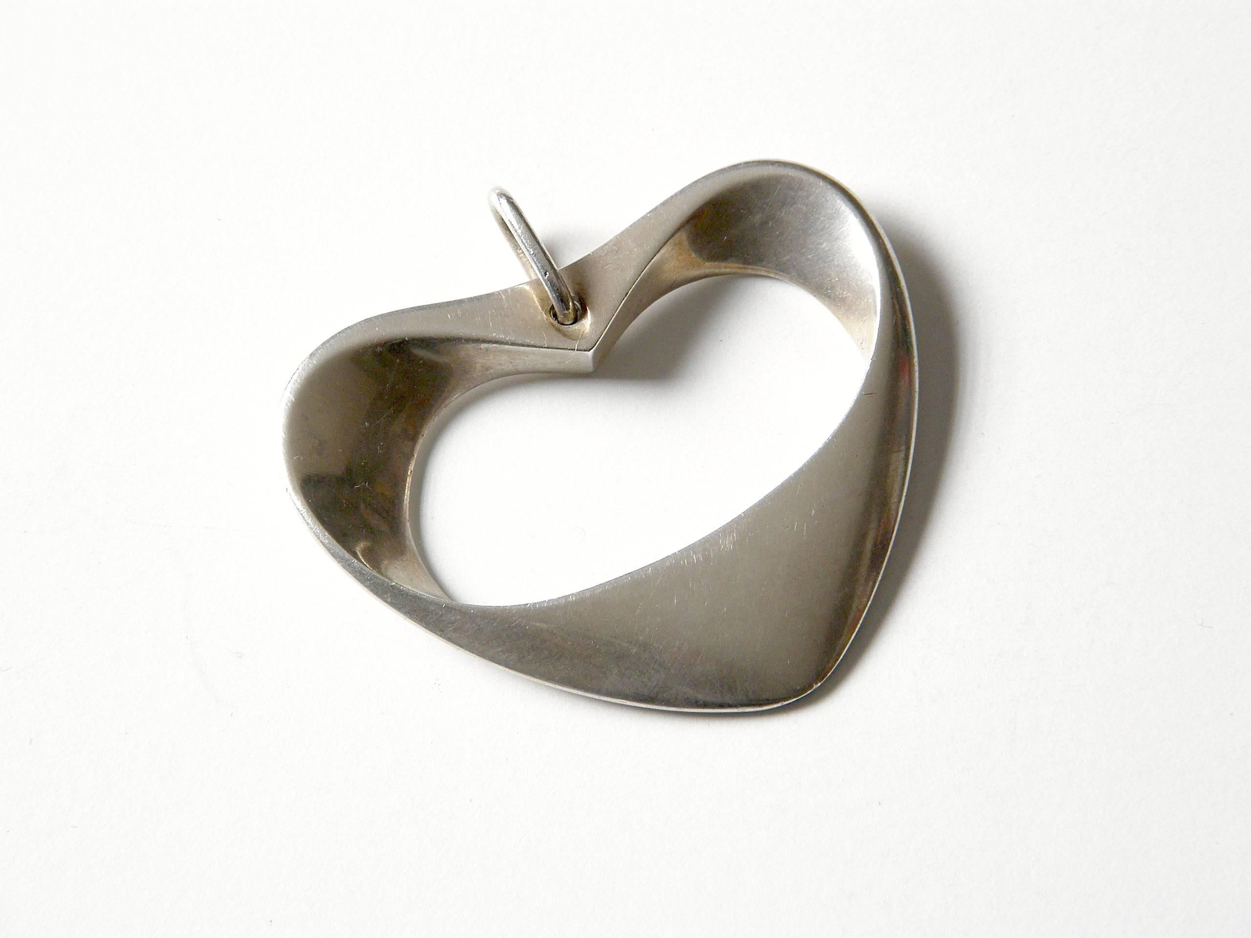 Modernist, sterling heart pendant designed by Henning Koppel for Georg Jensen. This is the larger size of the hearts of this design. The pendant is inscribed on the back and dated 11-6-53.

Please contact us if you have any questions.