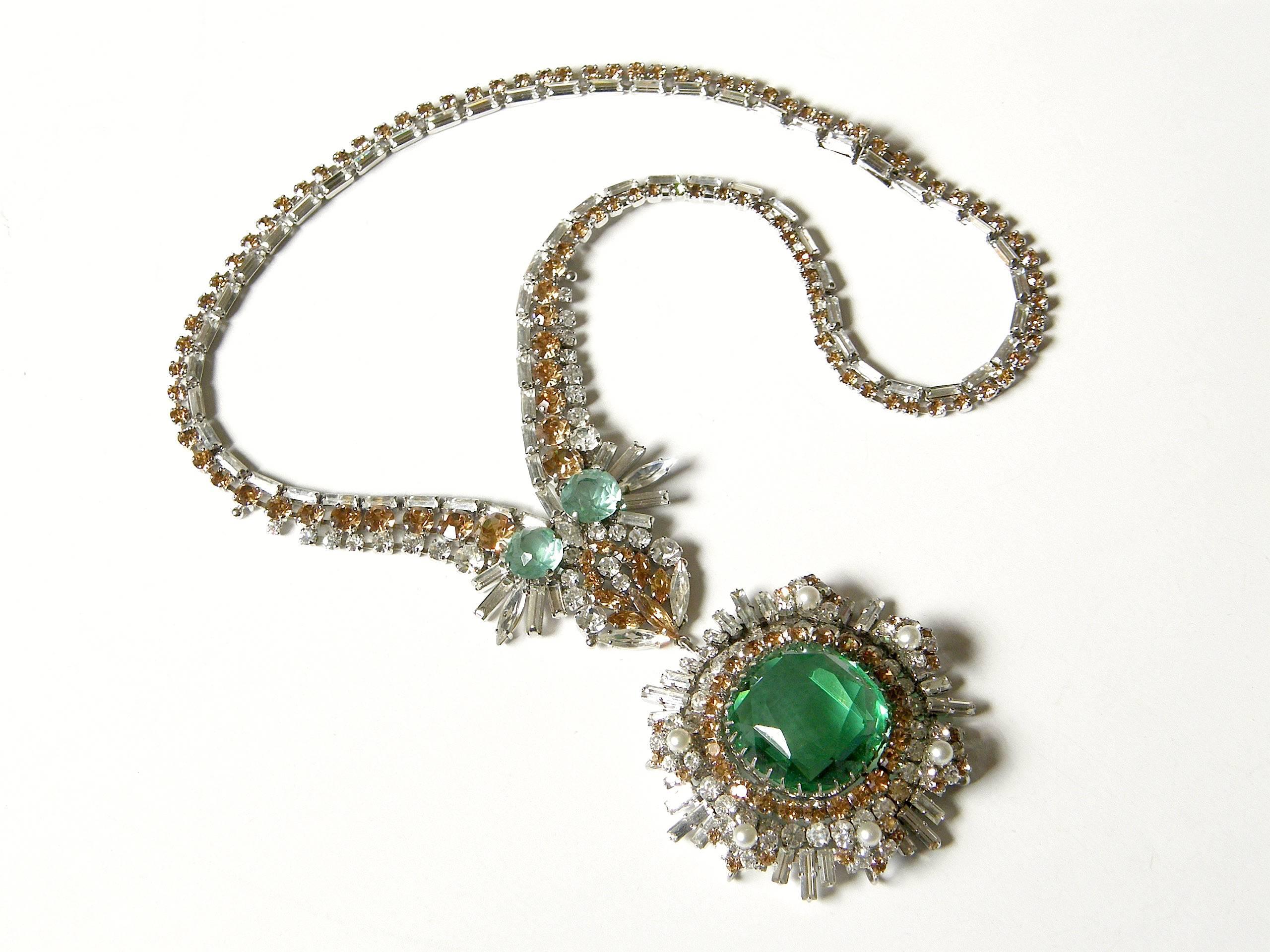 This exceptional rhinestone necklace features a huge, light green faux emerald 