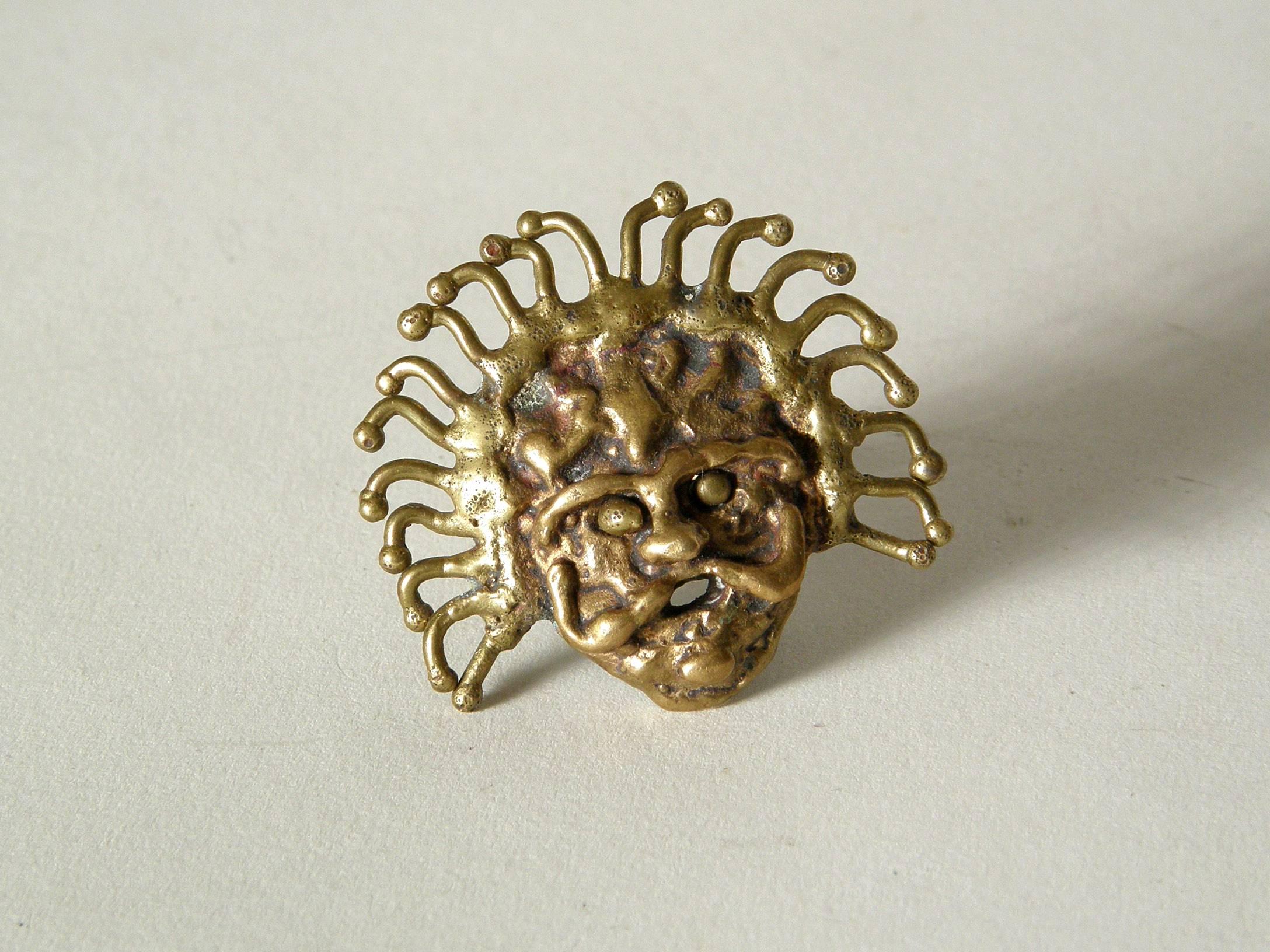 This brutalist face ring has a nice 3-dimensionality, especially with the pierced, open mouth. The molten brass face and radiating crown of hair are very expressive. We bought this ring with several other pieces, including a signed Pal Kepenyes
