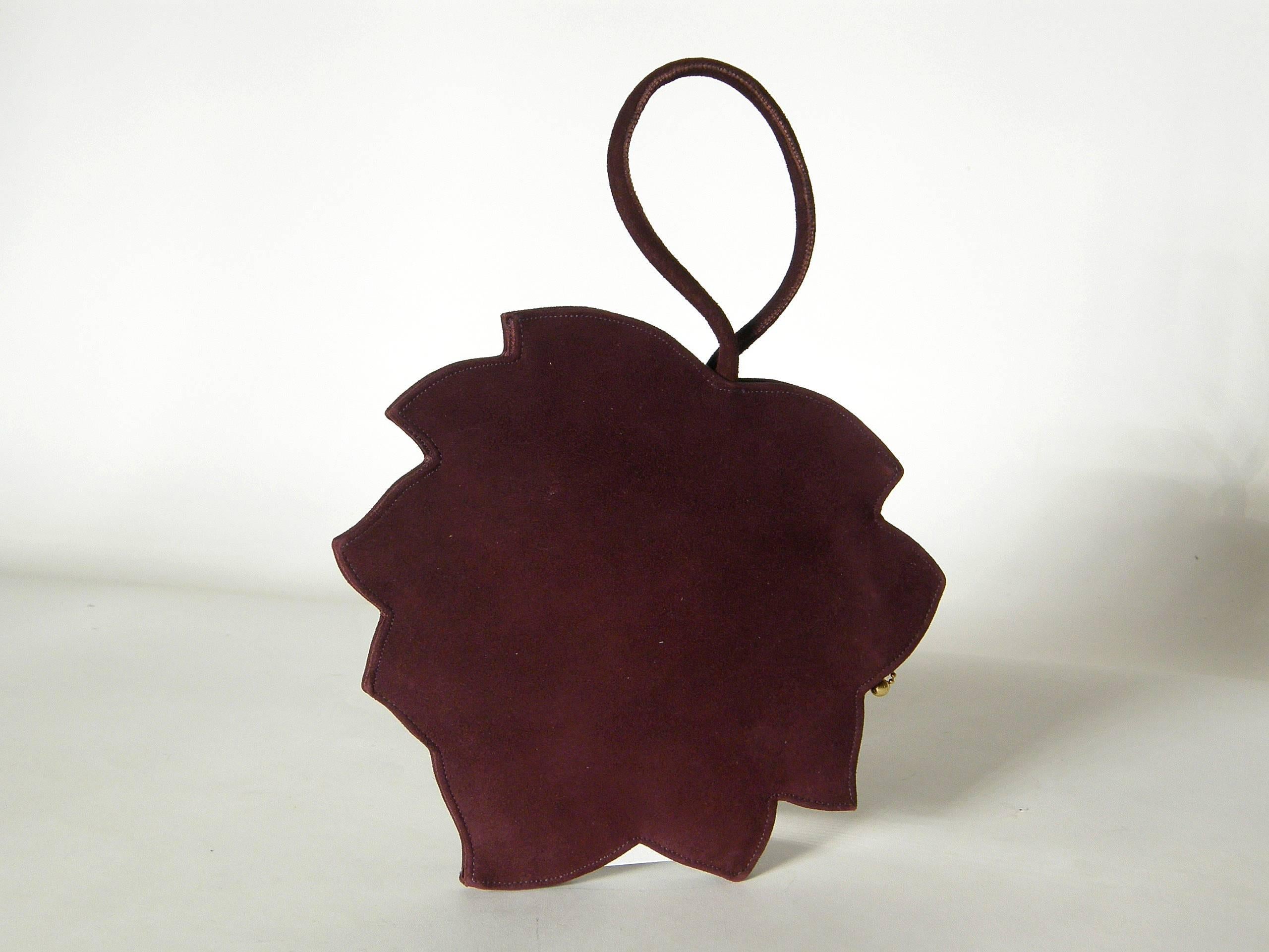This marvelous, figural handbag shaped like a realistic leaf is made of a gorgeous, aubergine colored suede with raised, stitched 