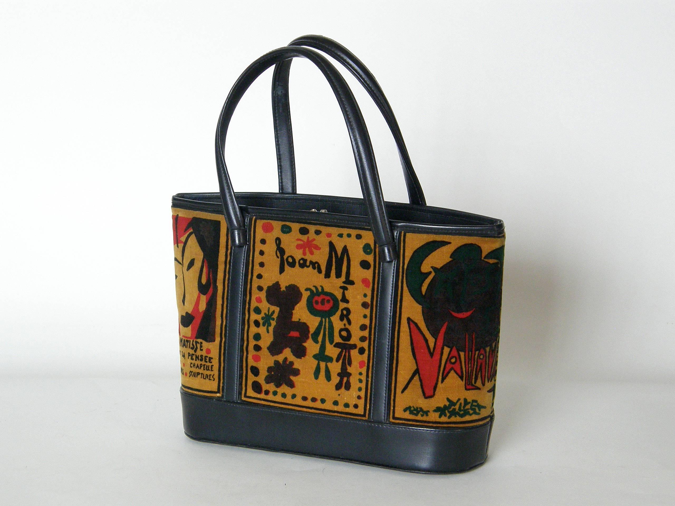 This tote style handbag has a black vinyl body with novelty fabric insets. The unusual velveteen fabric is printed with exhibition posters promoting the work of famous modern artists of the early to mid-20th century, such as Pablo Picasso, Henri