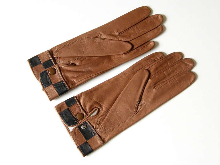 Chic, mod Pierre Cardin gloves in brown leather with black and brown checkerboard patterned cuffs. They are stamped with a size 7 on the lining.

Please contact us if you have any questions.