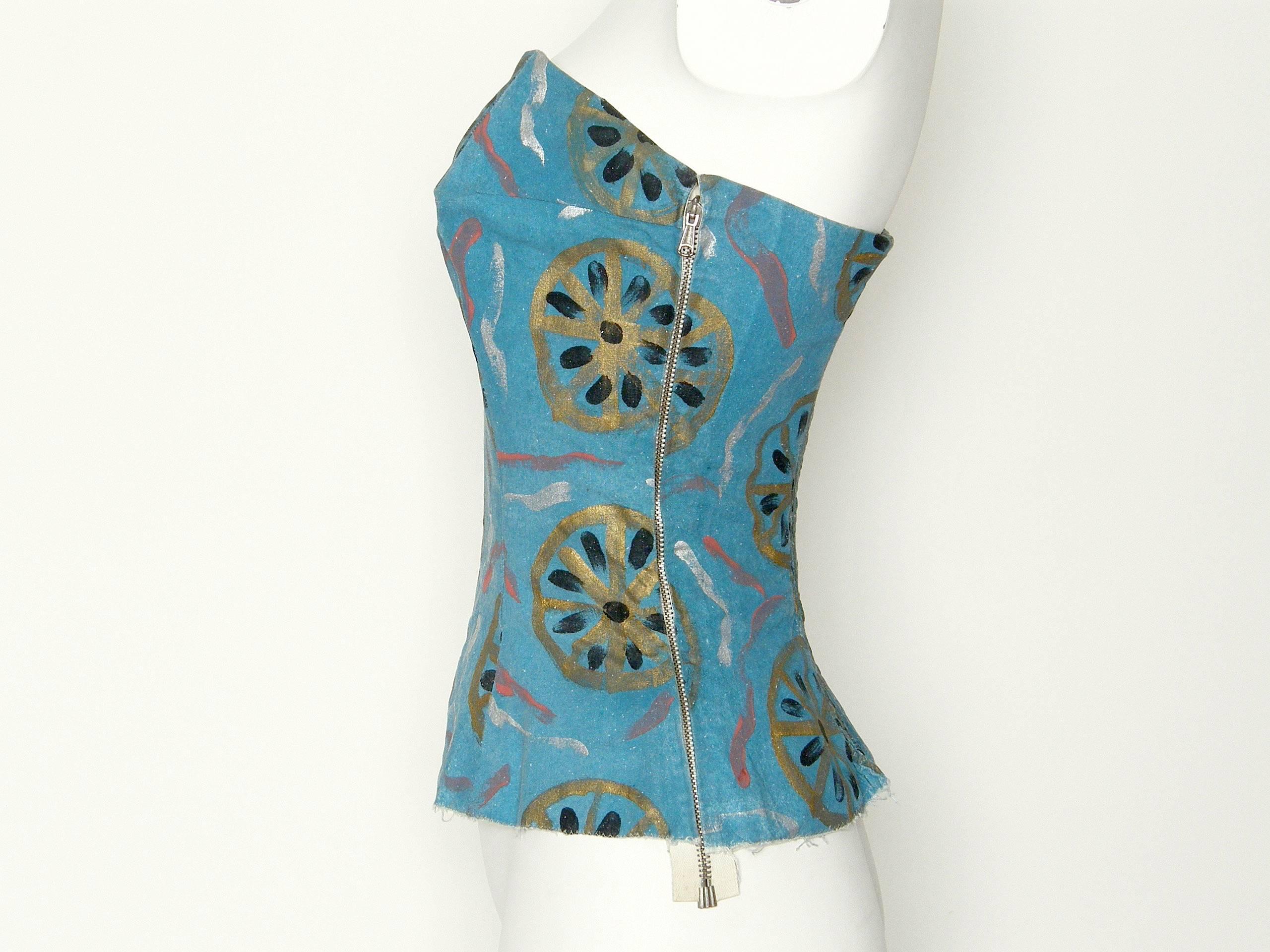 This rare and early Pucci bustier sun top is beautifully constructed. It's fully lined (except for the smocked panel in the back) with spiral steel bones, a petersham waist stay and side metal zipper. The fabric is not a typical Pucci print. The