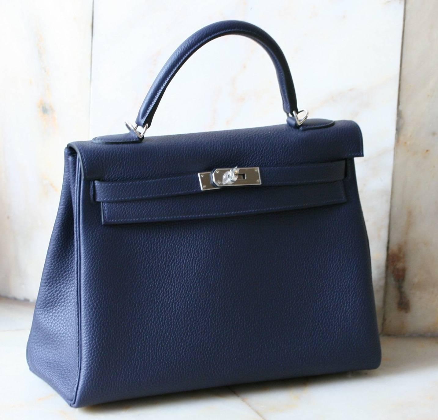 HERMES Kelly Bleu nuit togo '32 
Metal hardware, comes with complete packaging and accessories, original invoice.   Pristine, unworn condition
