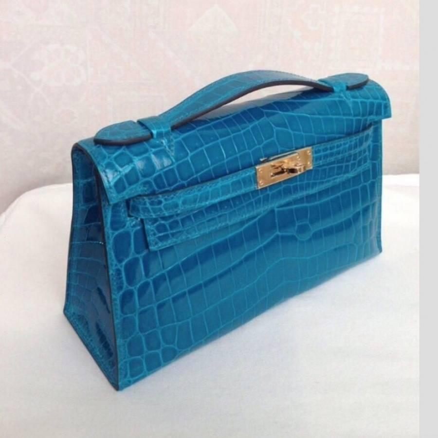 Mini Kelly in Blue Izmir Crocodile. 
Gold hardware, comes with complete packaging and accessories, original invoice.   Pristine, unworn condition