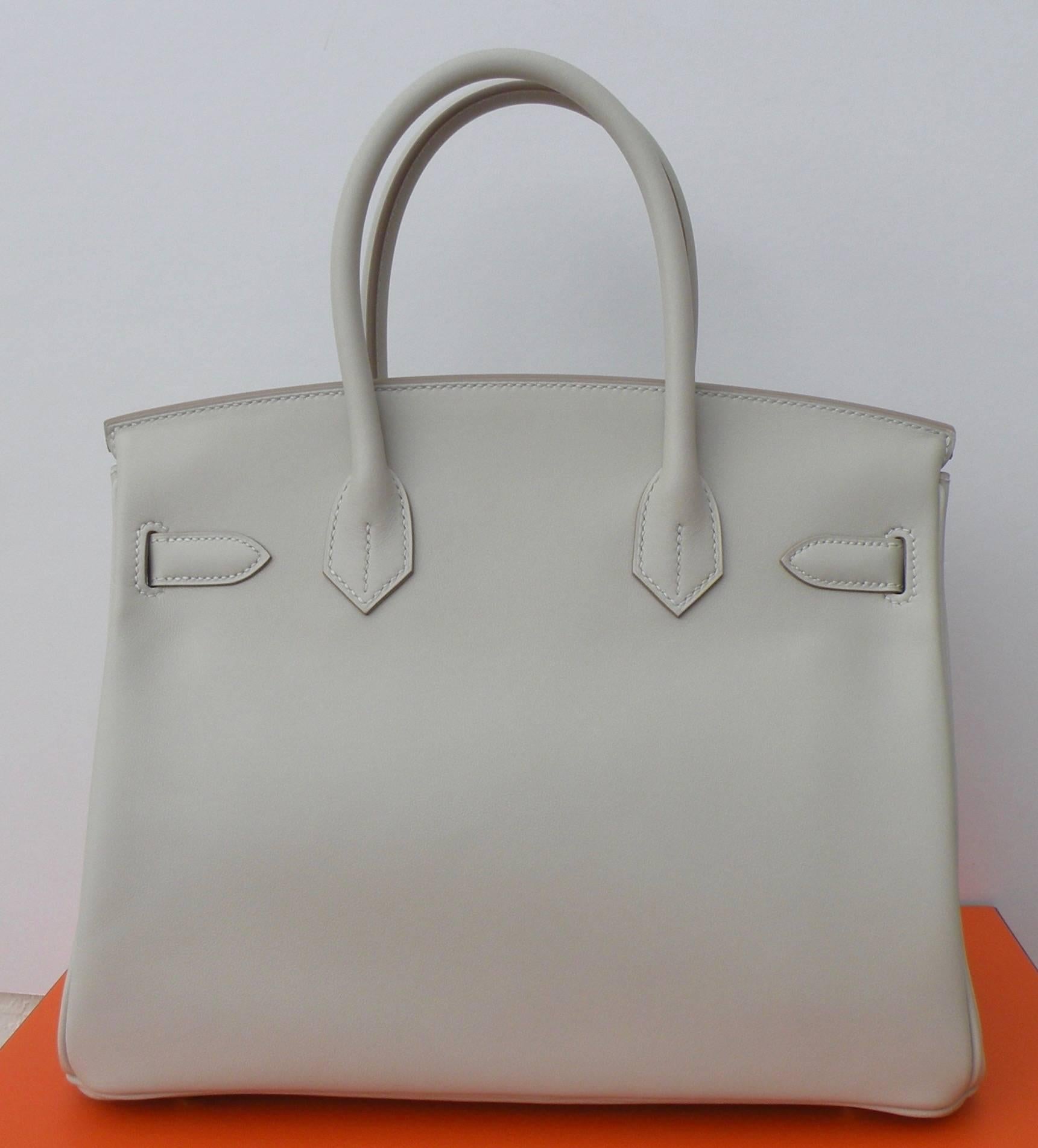 Hermes 30cm Birkin Bag in Beautiful Gris Perle, a light Grey, with contrasting Gold Hardware, makes this bag stunning!
Leather: Smooth Swift Leather
Hardware:  Gold
Size: 30cm 
12" Width x 8" Height x 6” Depth
New never worn
Comes with